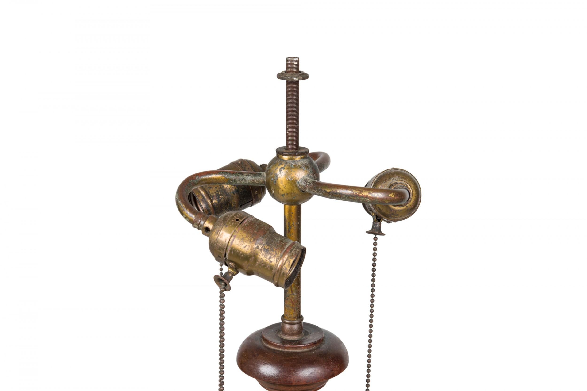 English Victorian elaborately carved mahogany floor lamp mounted with three brass electrified sockets and threaded finial post, with an urn-form upper section that tapers to a fluted column with turned detail flaring out to a square base with carved