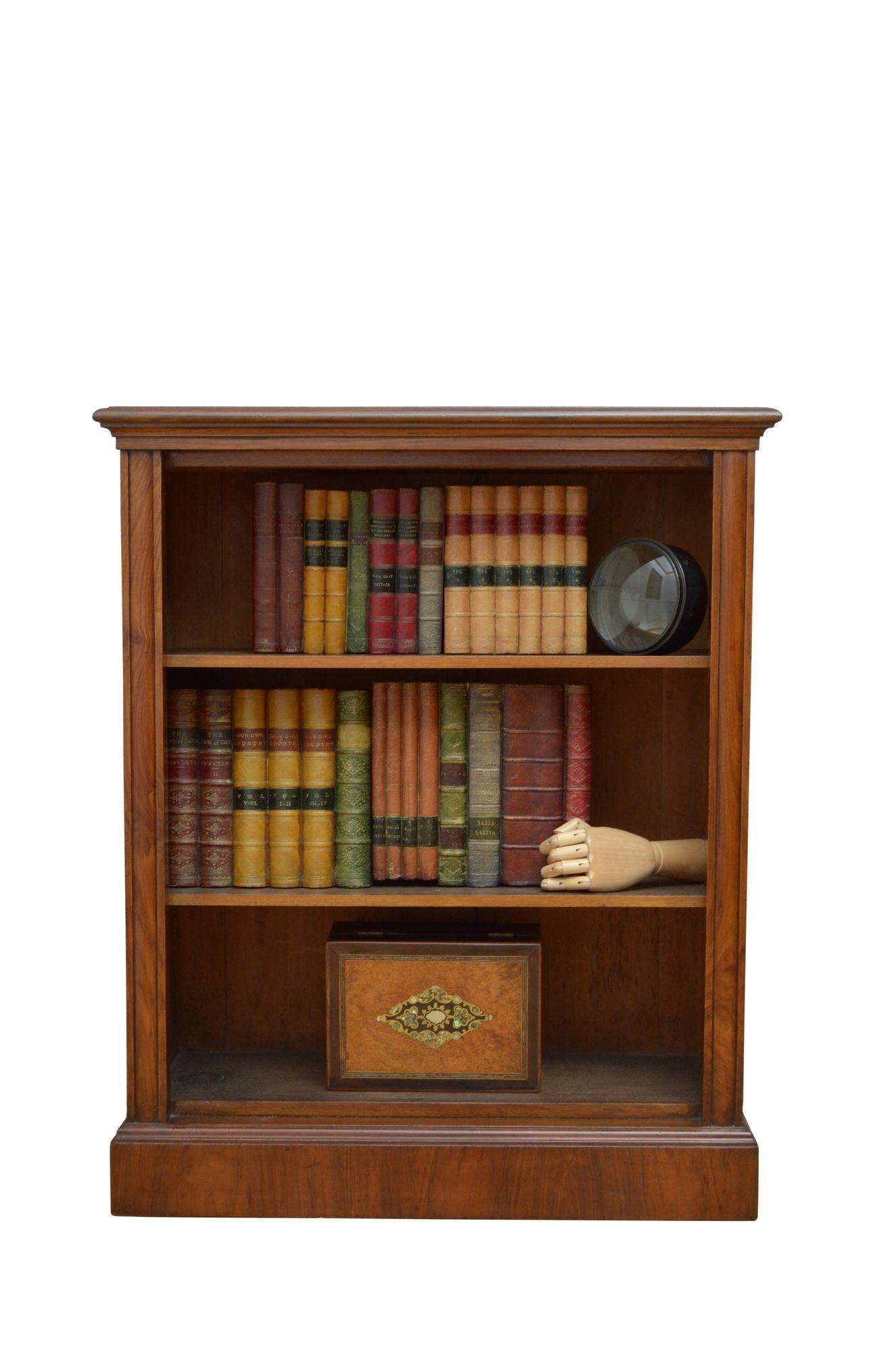 K0615 Fine quality and very attractive Victorian bookcase in walnut, having figured walnut top with moulded edge above two height adjustable shelves flanked by convex shaped pilasters, all standing on moulded plinth base. This antique bookcase is in