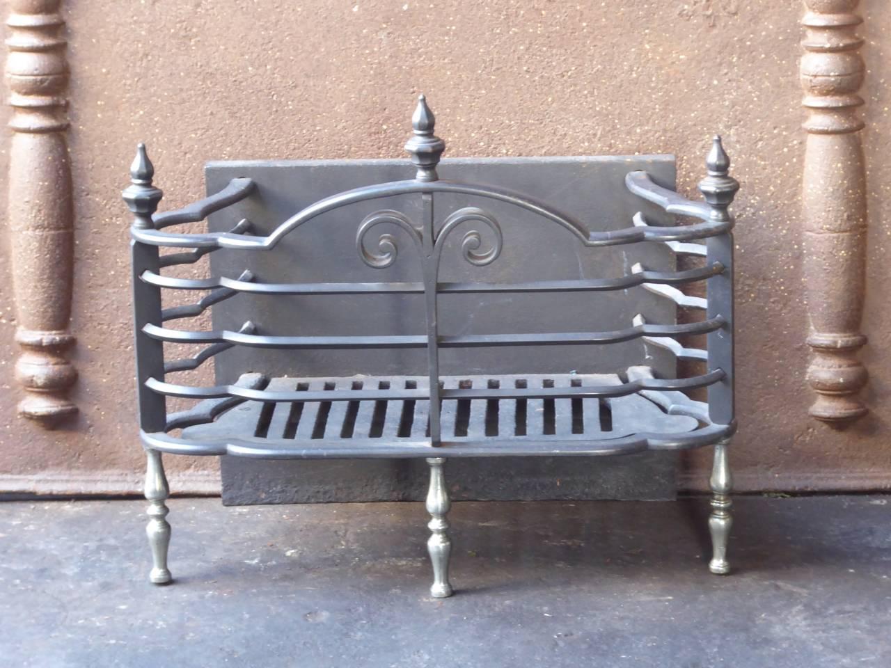 English Victorian fire grate made of cast iron, wrought iron and chrome. The total width of the front of the grate is 56 cm.

We have a unique and specialized collection of antique and used fireplace accessories consisting of more than 1000 listings