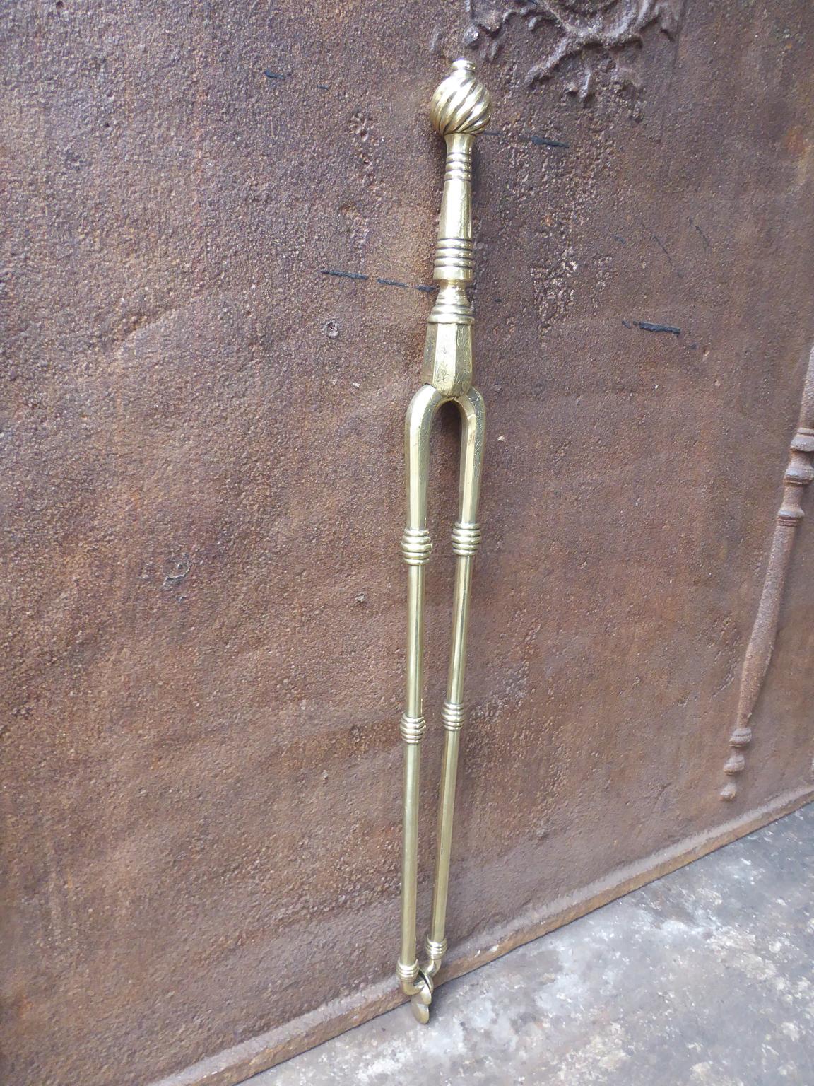19th-20th century English Victorian style fireplace tongs made of polished brass.







 