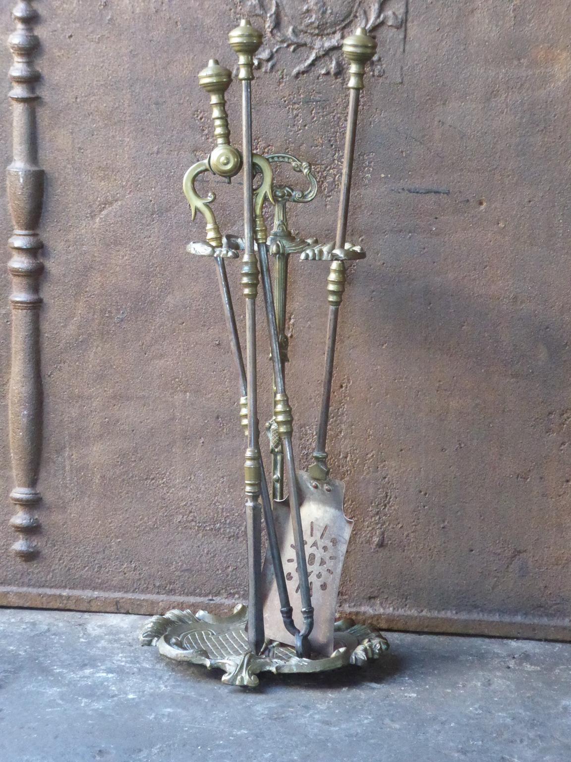 An elegant set of three tools with ring-banded shafts and round knopped finial handles. The companion set of fire irons is made of wrought iron and brass. It is in a good condition and is fully functional.