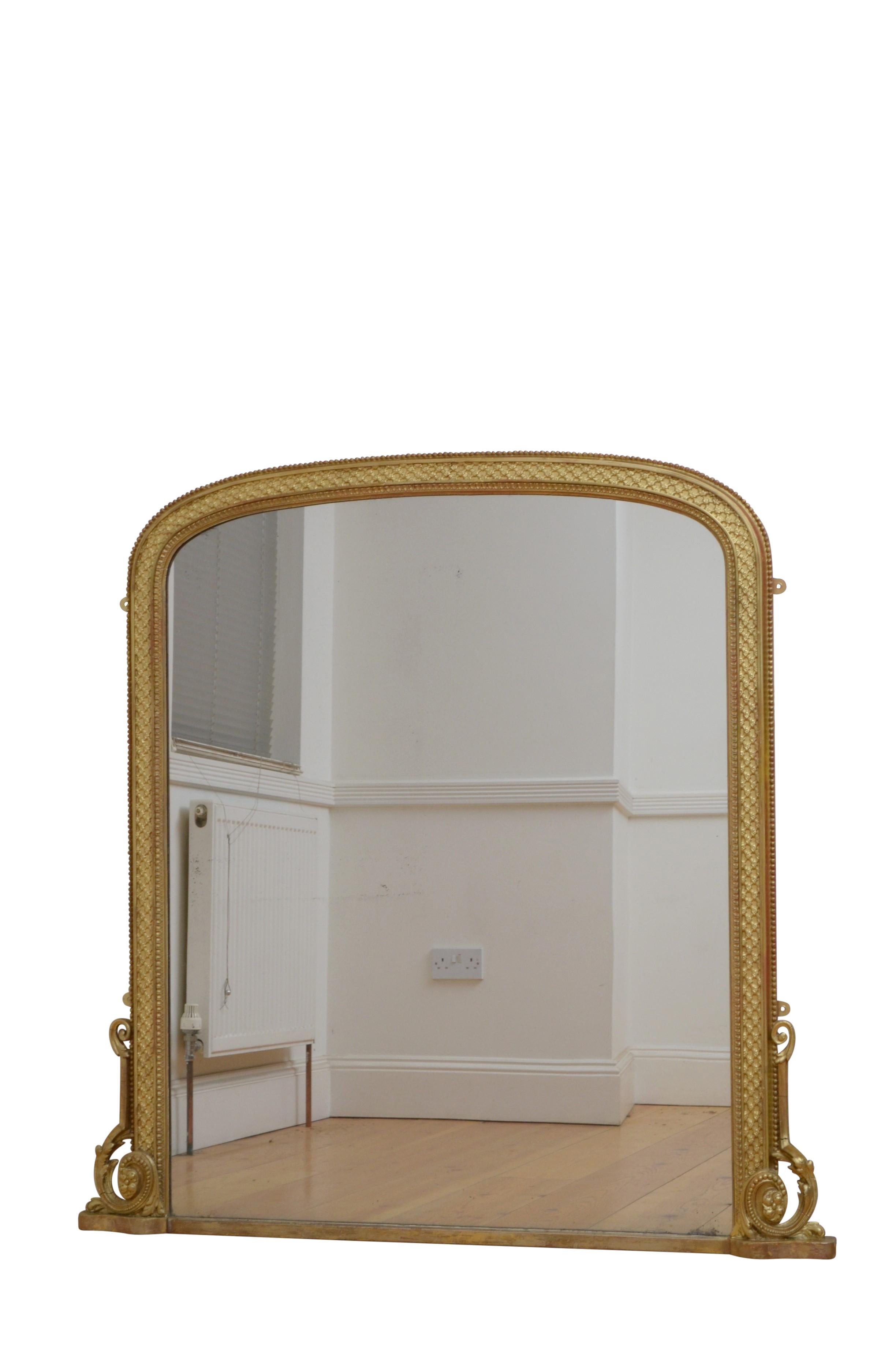 0585 Superb English gilded overmantel mirror, having original mercury glass with desirable sparkle and foxing in beaded gilded frame with lattice work and leafy scrolls to the base. This antique mirror retains its original glass, original gilt with