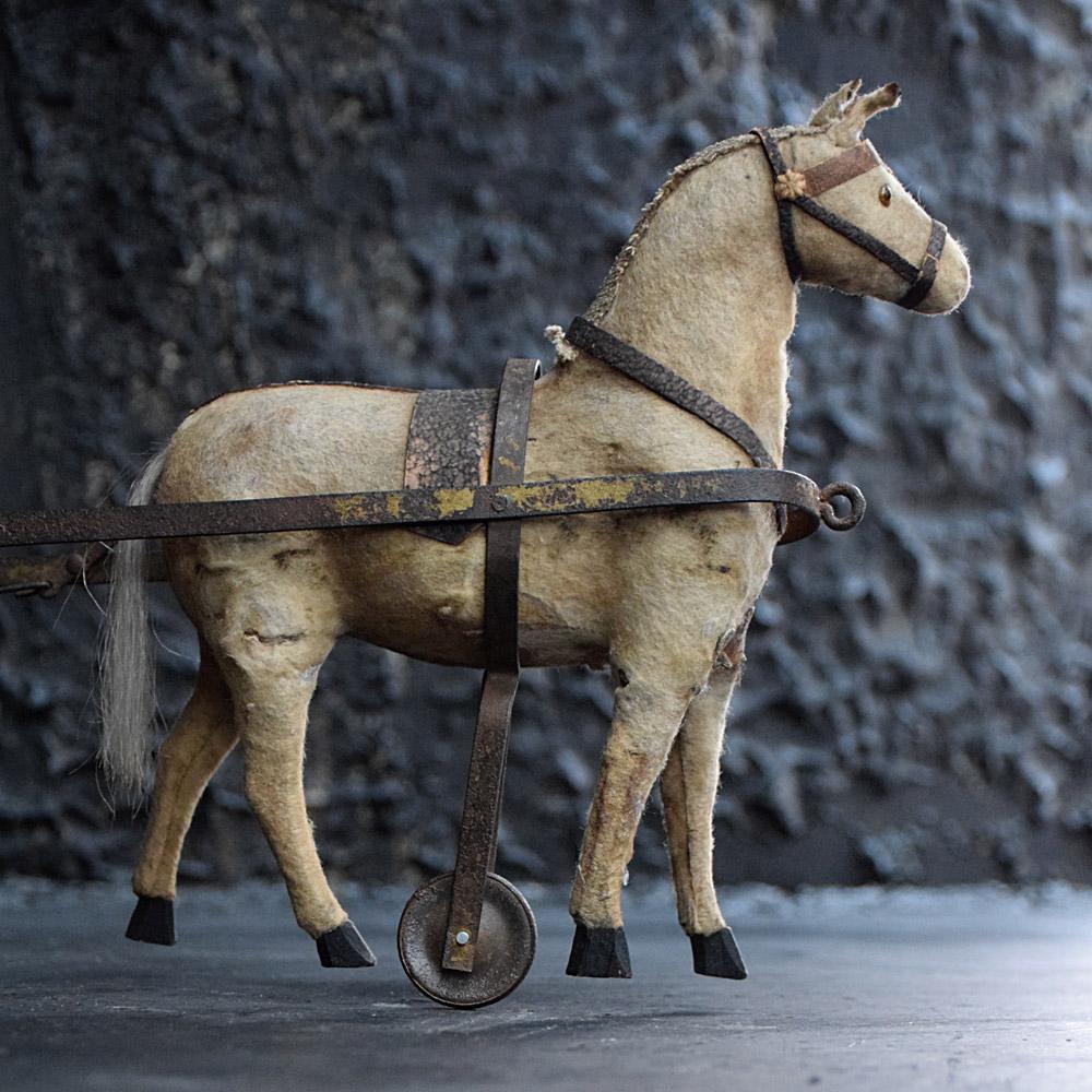 19th century child horse and cart toy
We are proud to offer a wonderful example of a late 19th century handcrafted child’s horse and cart toy. The horse is made from pony skin with real hair tail, a moving toleware metal cart which still has its