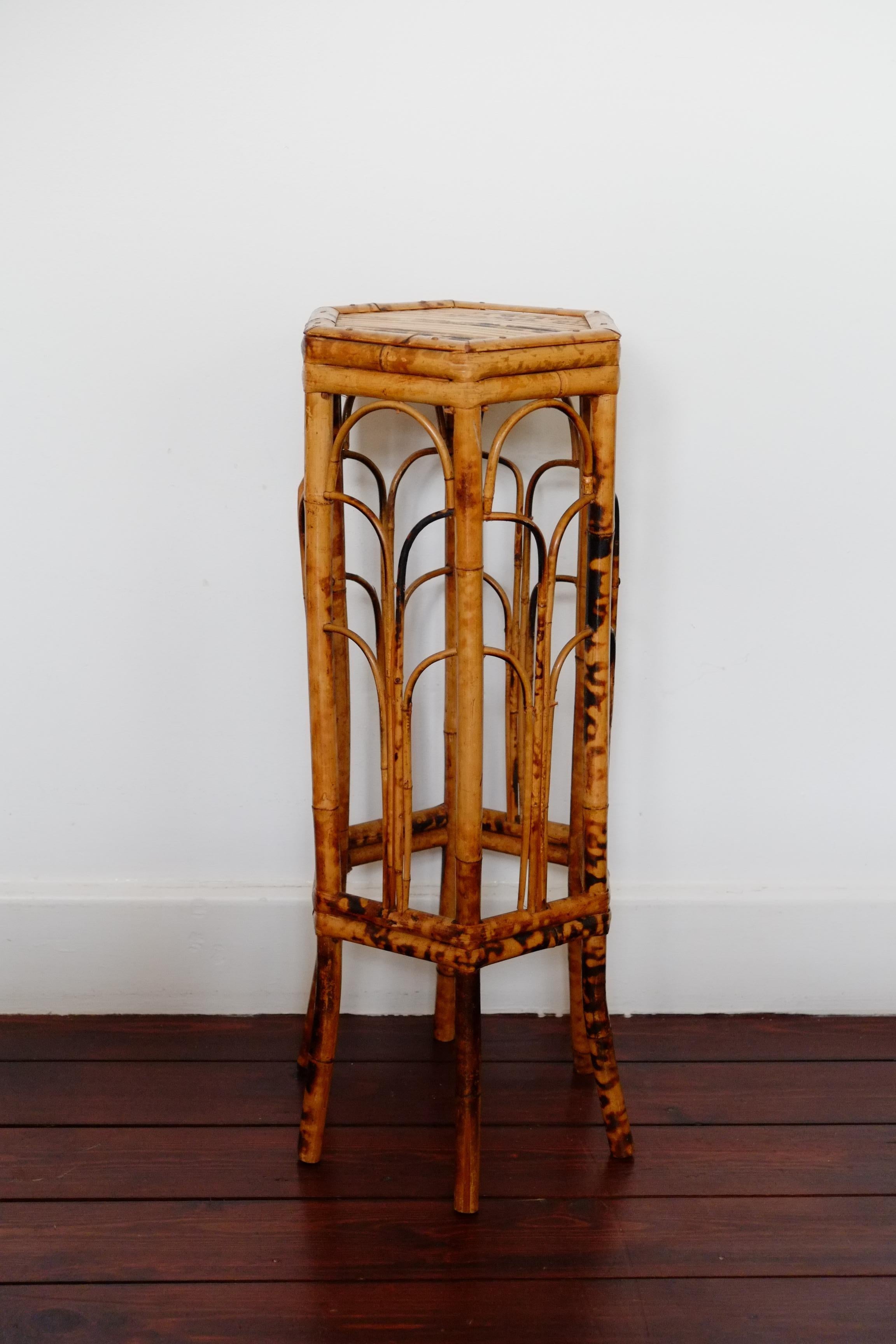 Un magnifique stand victorien en bambou. Ce support victorien a une belle forme hexagonale avec des pieds courbés à la vapeur. Le bambou est ébonié par endroits dans le style victorien traditionnel pour donner une finition écaille. Le bambou fendu