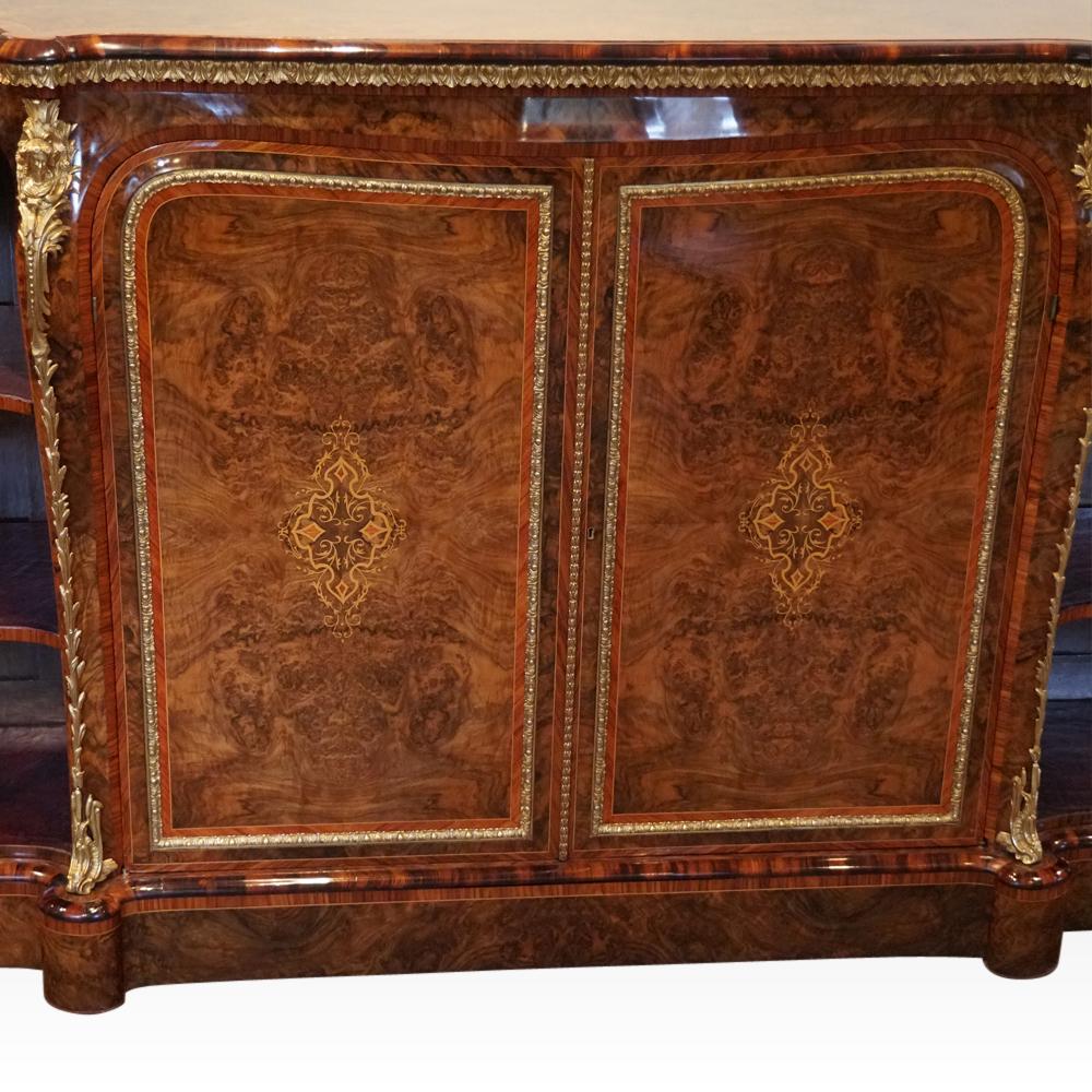 Victorian inlaid walnut side cabinet
This Victorian inlaid walnut side cabinet was made circa 1870 in one of the finest workshops of the period.
To each side of the pair of cupboard doors are display shelves lined in tooled leather.
The cupboard