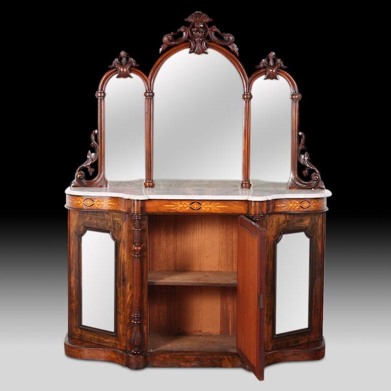 An English inlaid figured walnut side cabinet or ‘chiffonier’ with three lower mirrored-front doors below an inlaid serpentine frieze and original shaped marble top. Original triple mirror top with ornately carved frame.