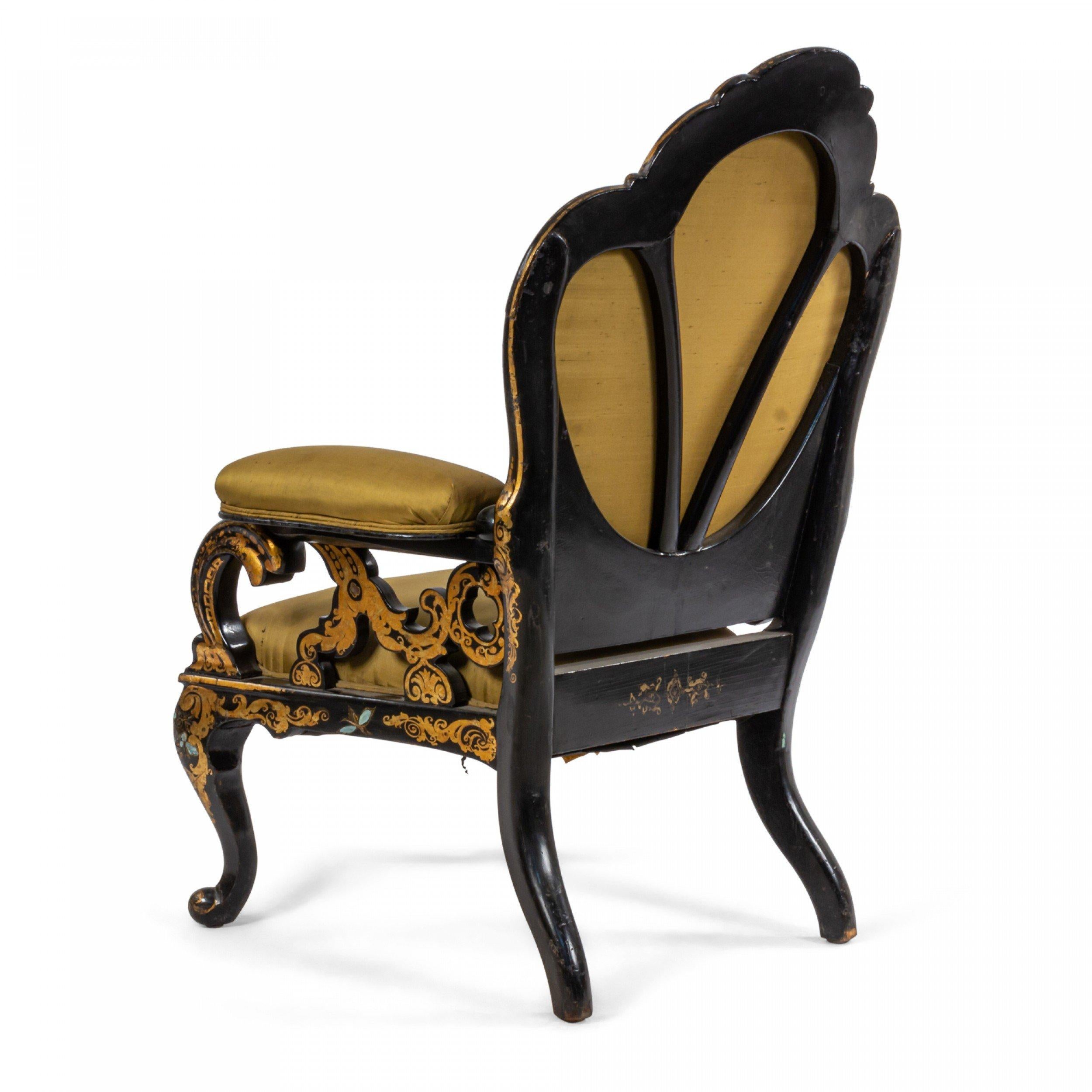 English Victorian black lacquered papier-mache armchair with pearl inlay, gold stenciled design, scalloped back, open work design arms, and green satin upholstery.
 