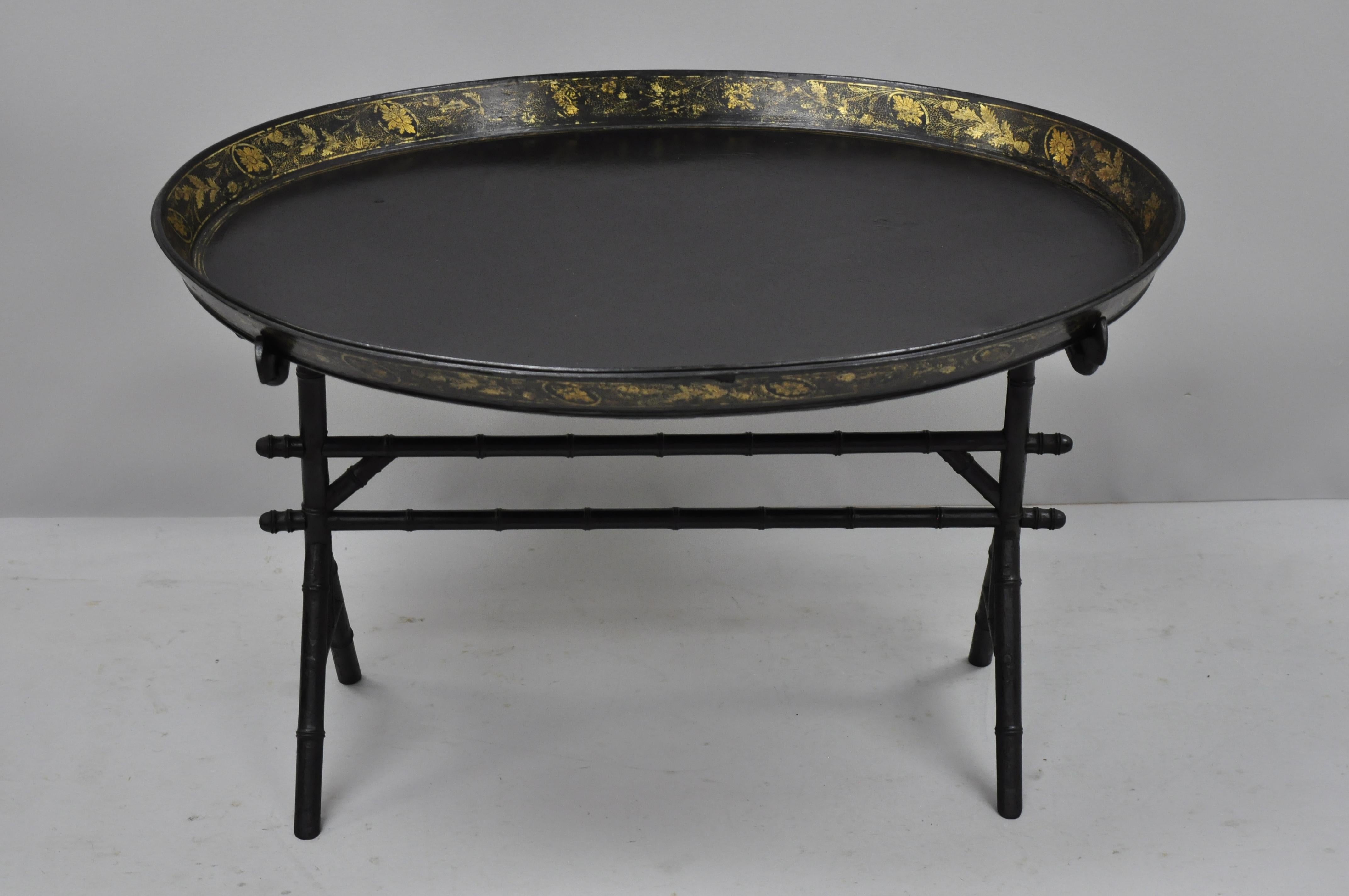 19th century English Victorian leather tole tray coffee table on faux bamboo base. Item features gold gilt decoration to leather wrapped removable tray, faux bamboo wooden base, very nice antique item, circa 19th century. Measurements: 21