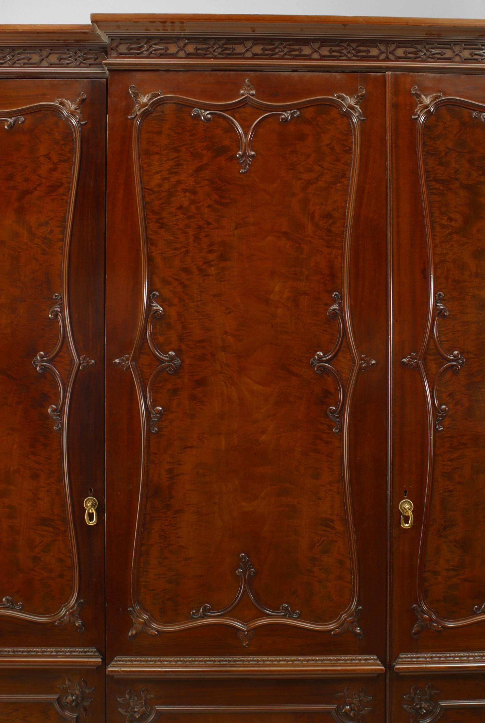 English Victorian mahogany armoire cabinet with 4 doors have a carved design framing a burl wood panel with a fretwork design cornice
