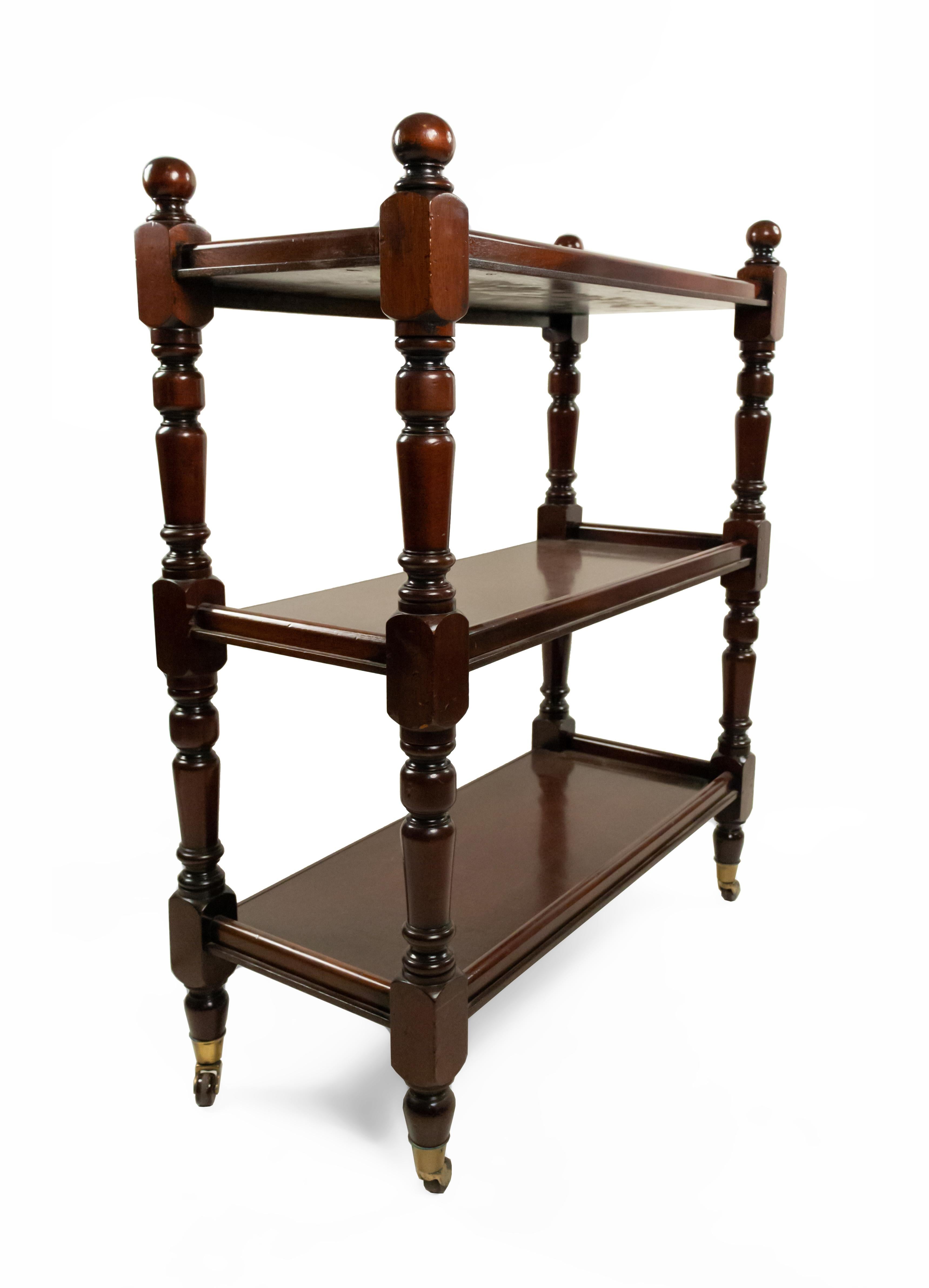 English Victorian mahogany 3-shelf étagère with four finials and casters on legs.