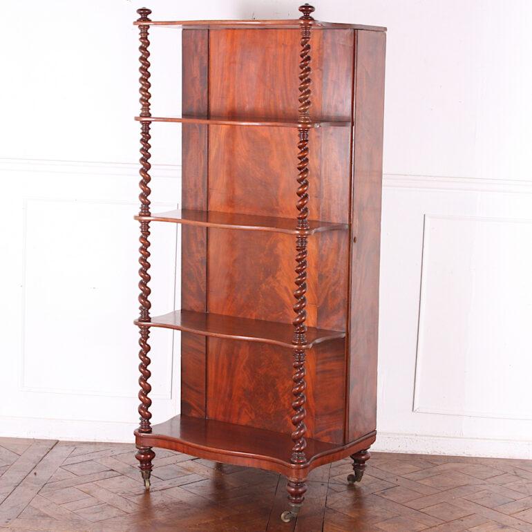 An English mid-Victorian barley twist five-tier etagere or whatnot stand with a cabinet section originally for storing table leaves from a Victorian banquet table.