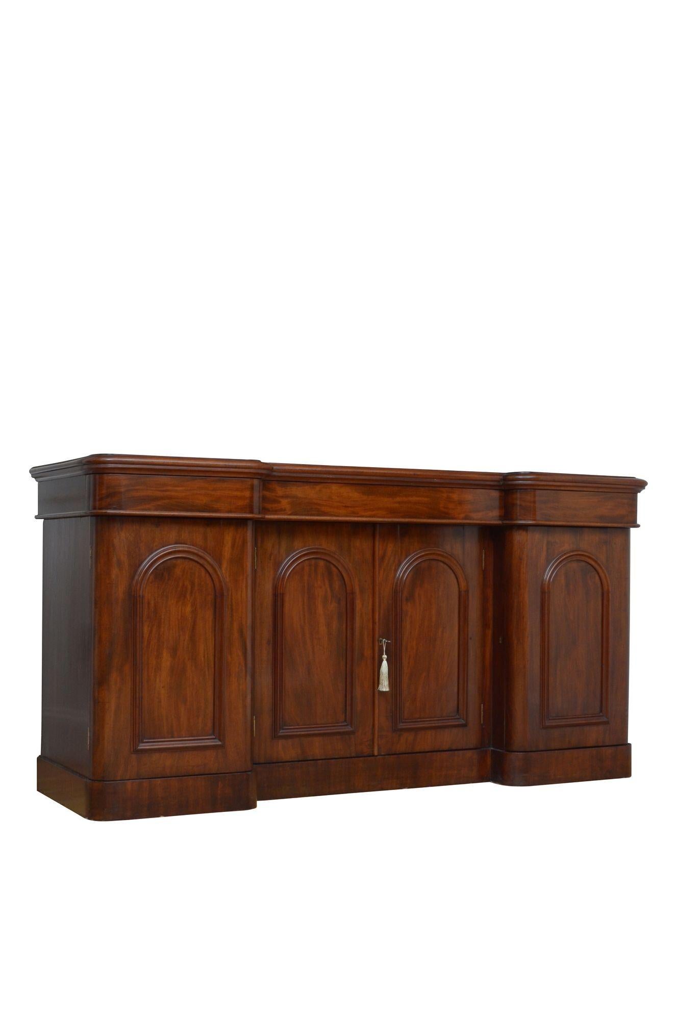 K0600 A fine quality English, Victorian mahogany four door breakfronted sideboard, having figured mahogany top with moulded edge, three oak lined, frieze drawers with newly lined with baize above arched and panelled, figured mahogany cupboard doors
