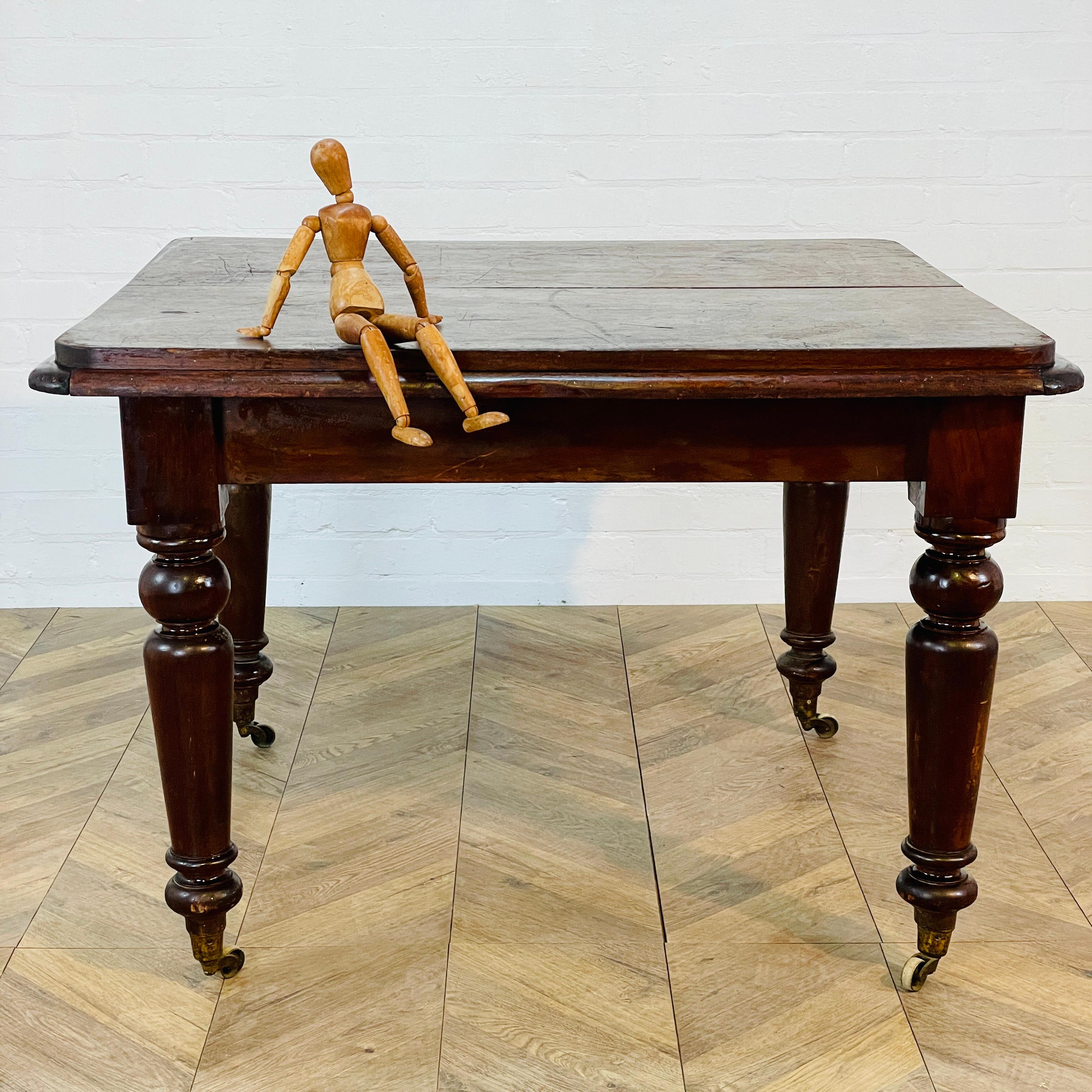 A Real Frankenstein’s Monster of a Dining Table!

Circa Late 19th Century, English Mahogany Dining Table on Original Brass Castors.

At some point the table has been cut down to not extend and fixed.

The table boasts a beautiful warm patina, with
