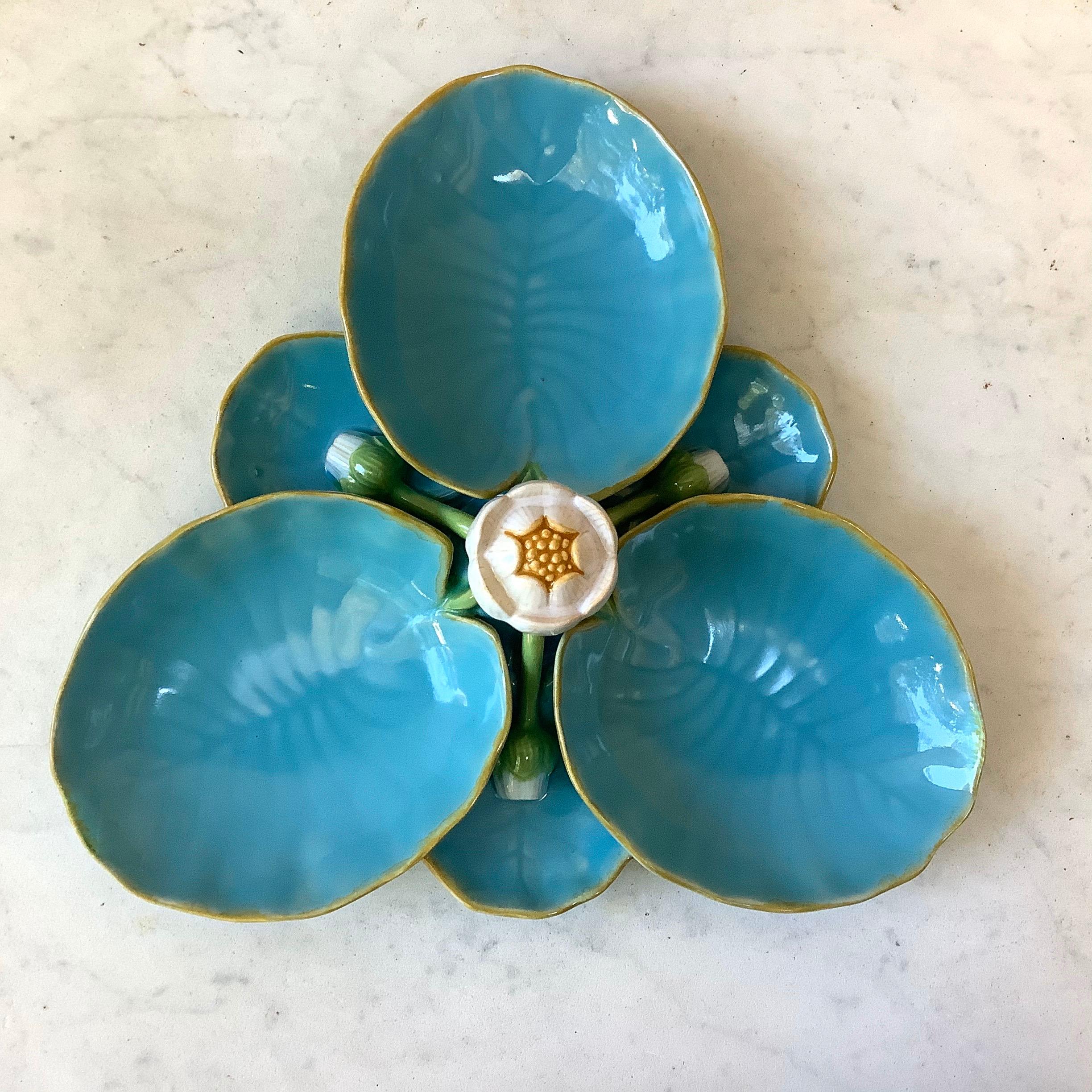 English Victorian Majolica signed Minton ‘Lily Pad’ Serving Dish circa 1875 modelled as three large conjoined lily pad bowls separated by three smaller lily bowls all with buds, the central handle formed as a lily flower.
Rare aqua color.
 