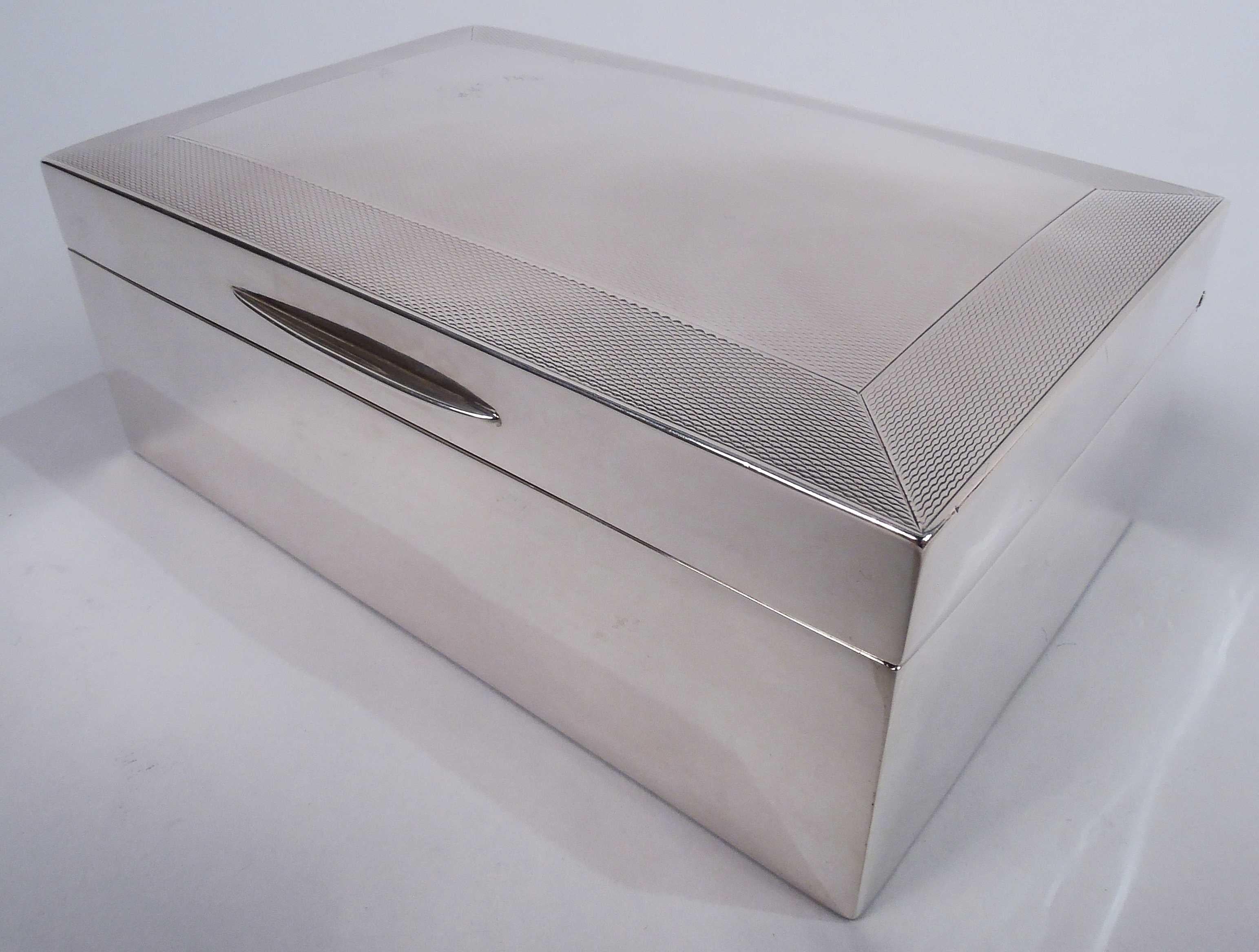 Victorian Modern sterling silver box. Made by Joseph Braham in London in 1895. Rectangular with straight and plain sides. Cover hinged and tabbed; top gently curved engine turning bordered by same. Box interior cedar lined. Cover interior