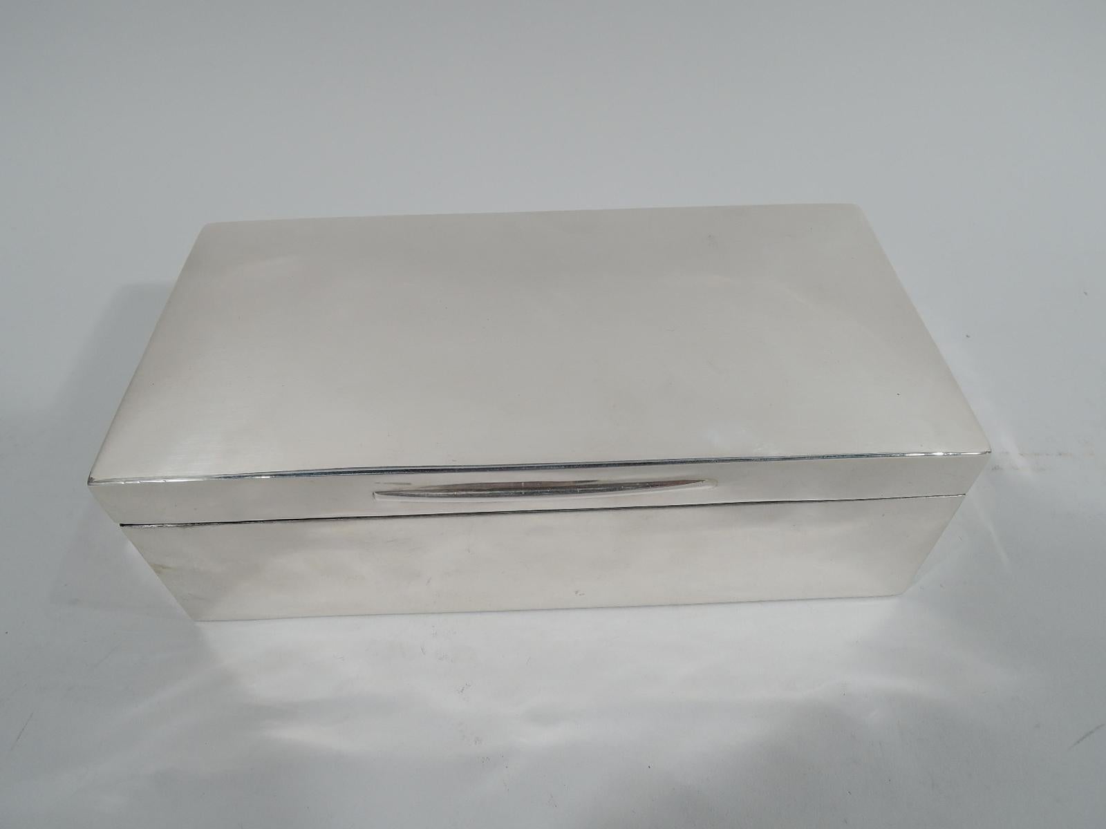 Victorian modern sterling silver box, 1897. Rectangular with straight sides and angular corners. Cover hinged and gently curved with tapering tab. Box and cover interior cedar lined and partitioned. Box underside leather lined. Fully marked