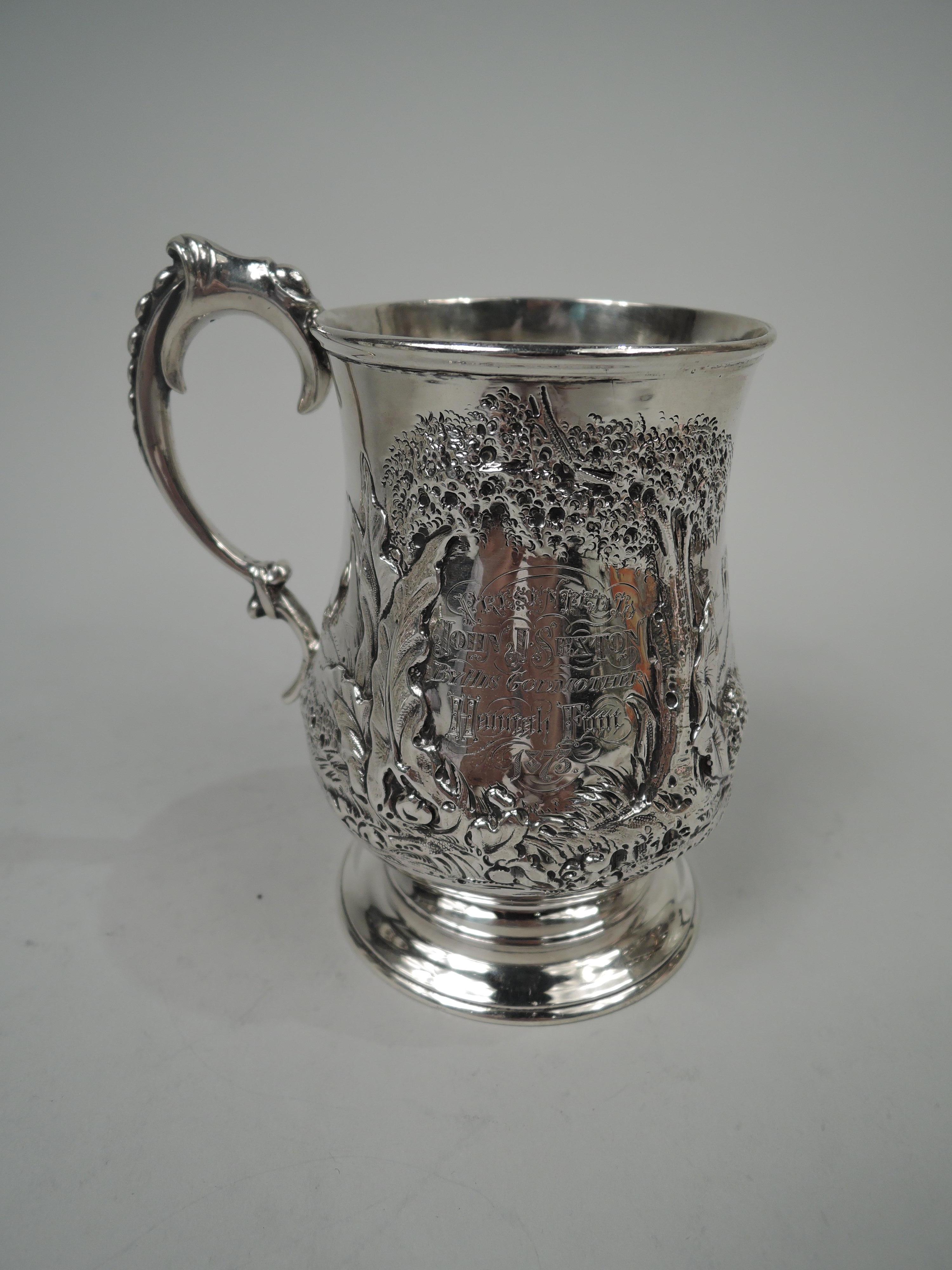 Victorian sterling silver baby cup. Made by Robert Harper in London in 1871. Baluster bowl on raised foot; wrapped and bracketed double-scroll handle with graduated beading. Chased and engraved scene from Robinson Crusoe: In the foreground stands