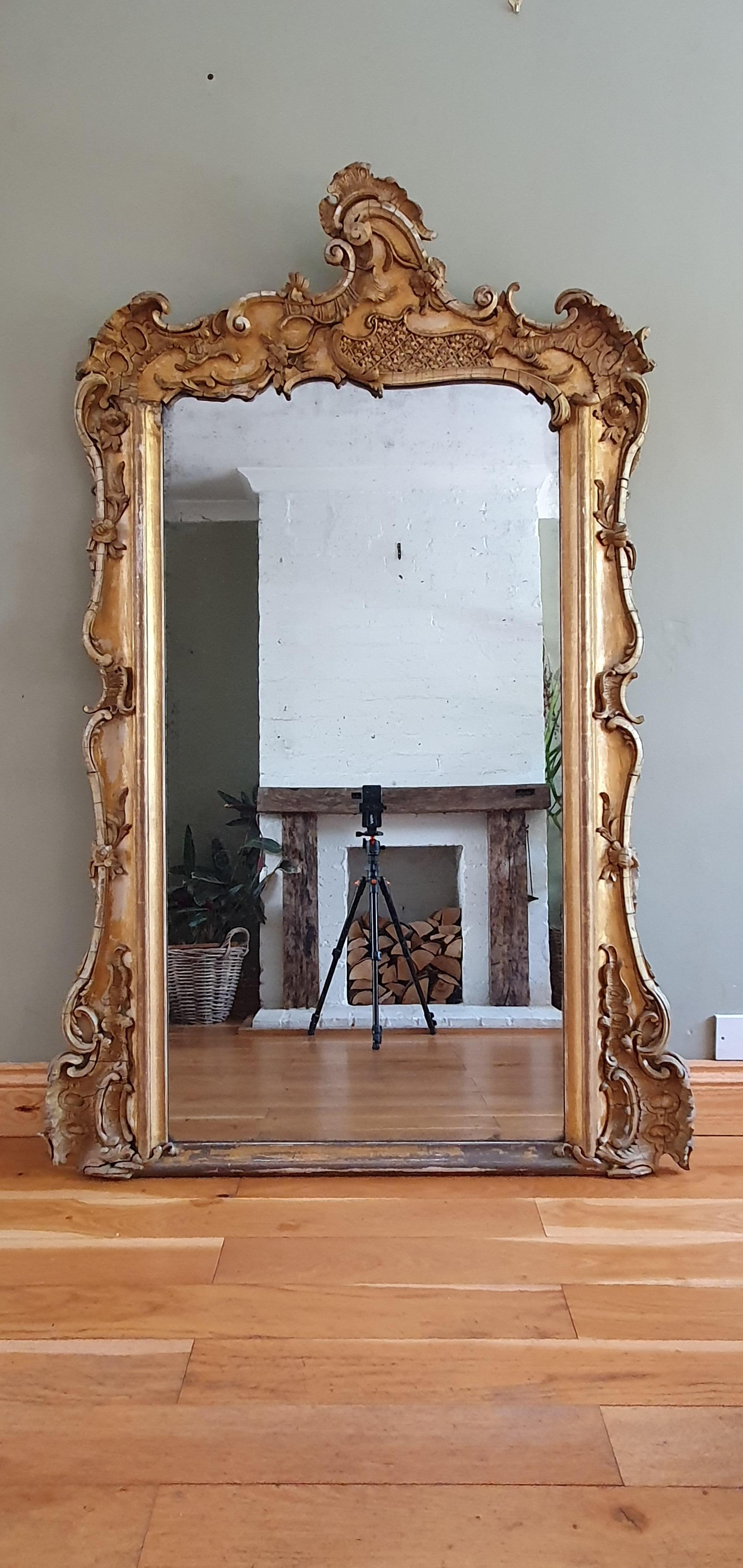 English overmantel/console table mirror, circa 1860. All in original condition (some ornaments missing) with original mercury glass.  Lovely rococo composition ornaments, very decorative and quite rare design. 
