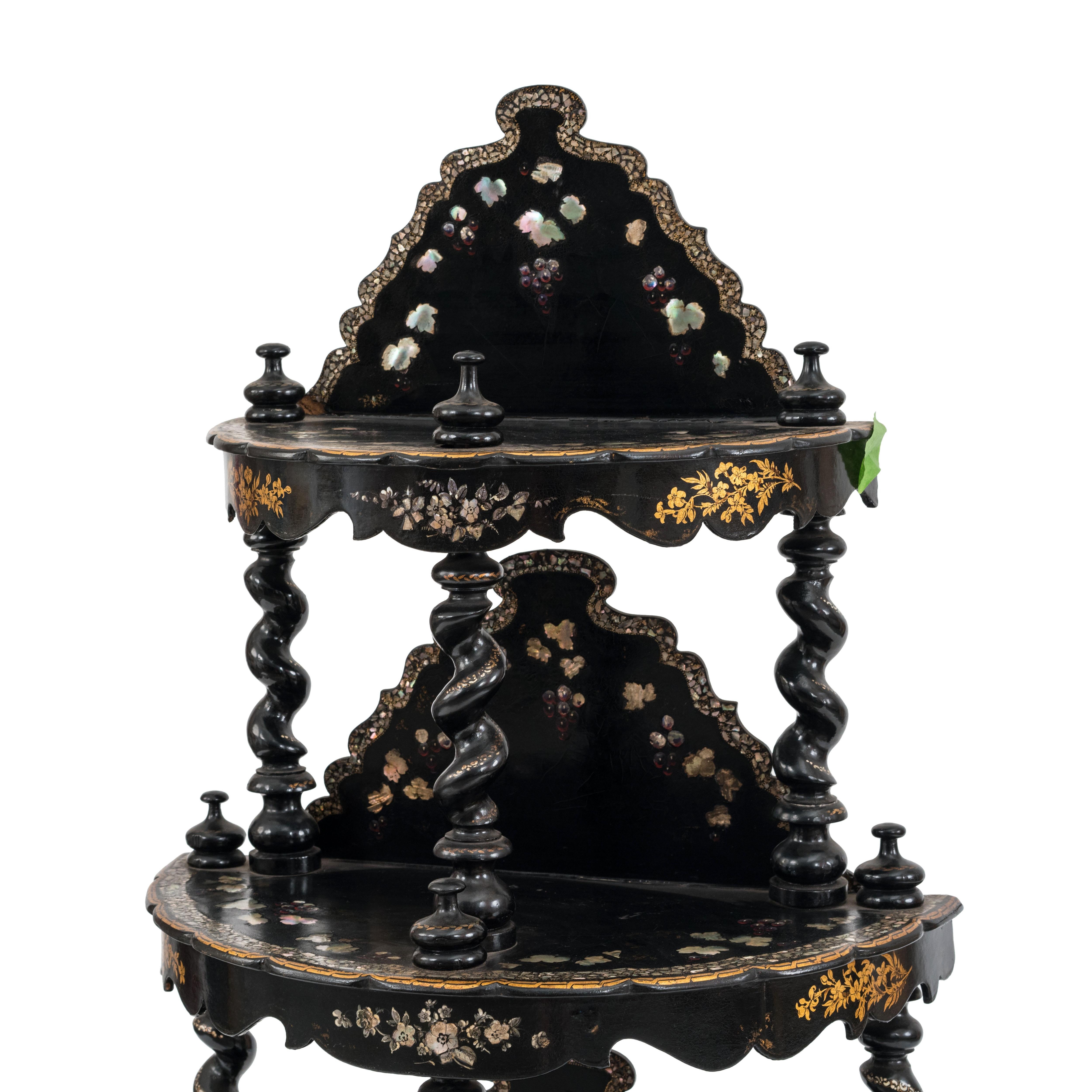English Victorian papier mache pearl inlaid black lacquered 4-tier etagere with turned legs and supports with back rail.
    