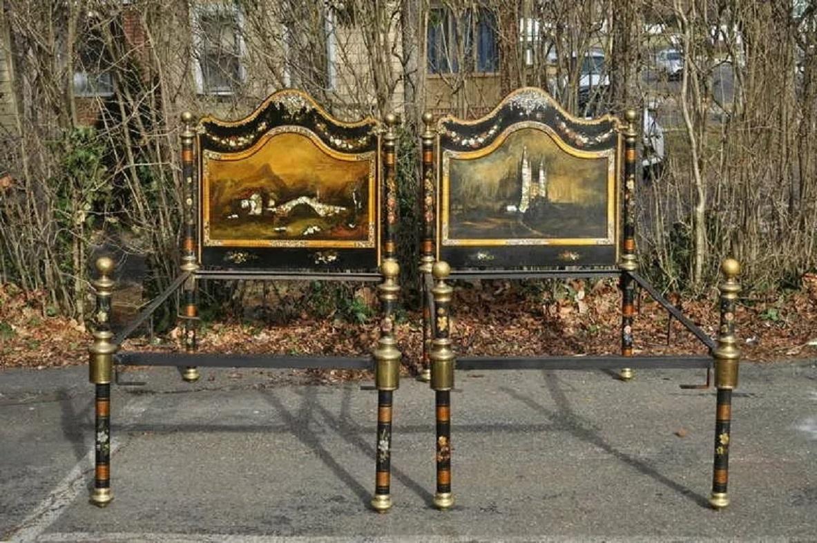 Remarkable pair of antique, 19th C, hand painted and mother of pearl inlaid signed single beds. This breathtaking pair features wrought iron paint decorated frames, brass cannon ball finials, and hand painted and detailed oil paint on wood