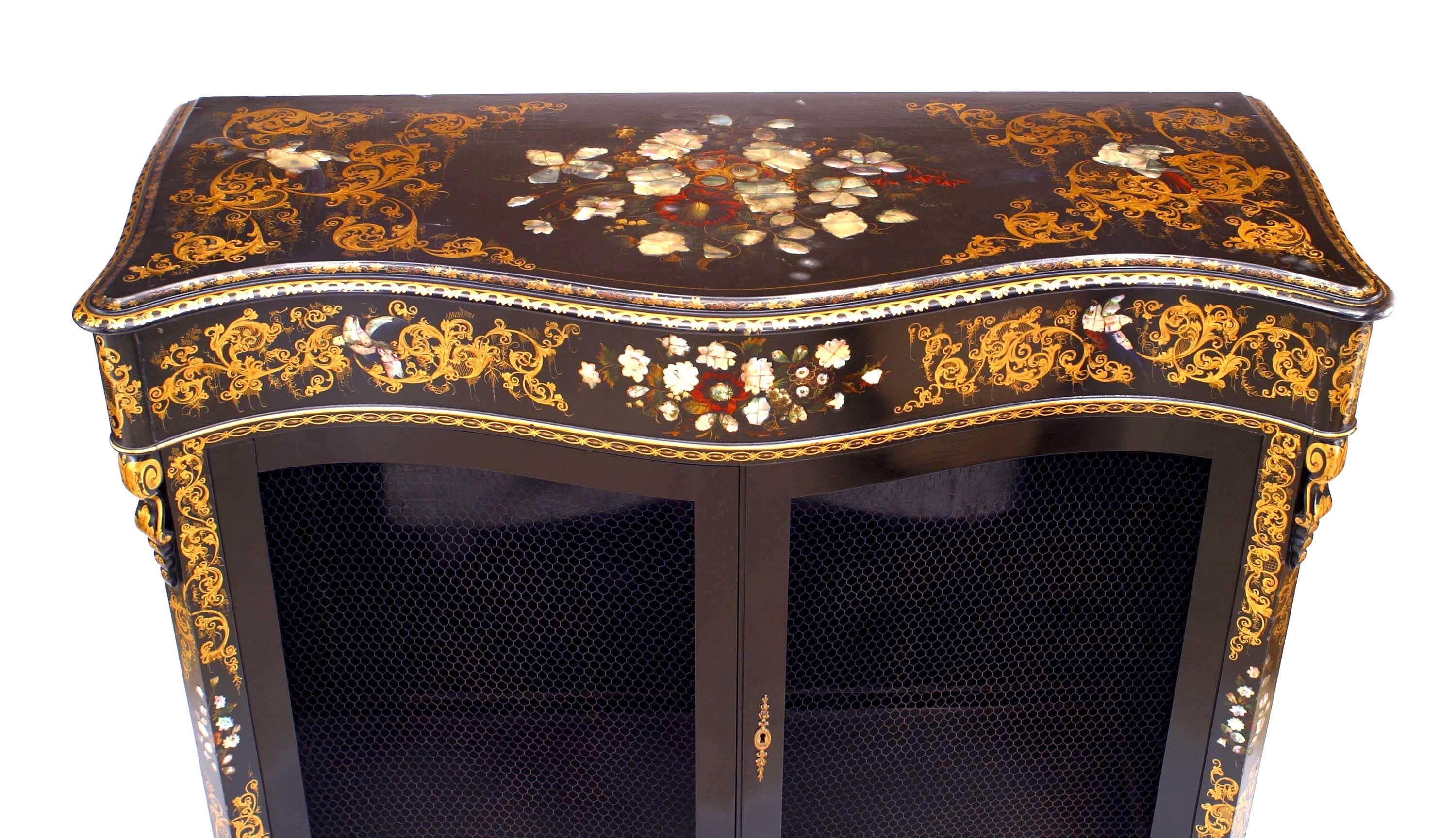 English Victorian papier mache pearl inlaid black lacquered cabinet with serpentine shape and 2 grill doors.
