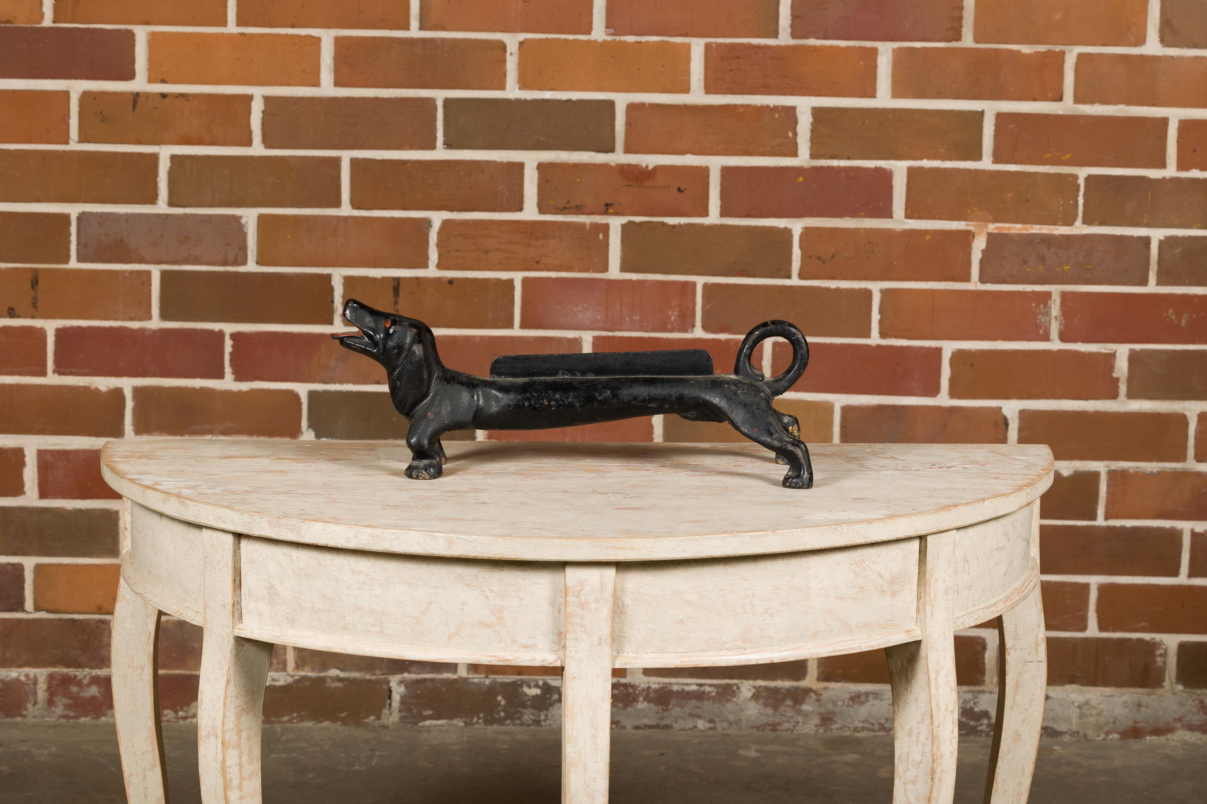 An English Victorian period iron boot scraper from the 19th century depicting a Dachshund dog. This English Victorian iron boot scraper from the 19th century is not just a functional piece but a charming work of art that adds character to any home.