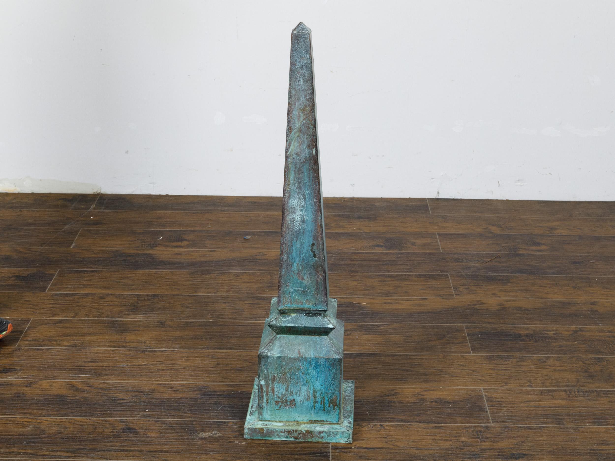 An English Victorian period painted metal obelisk finial from the 19th century with turquoise, blue and light green painted accents and weathered appearance. This English Victorian period obelisk finial from the 19th century captivates with its