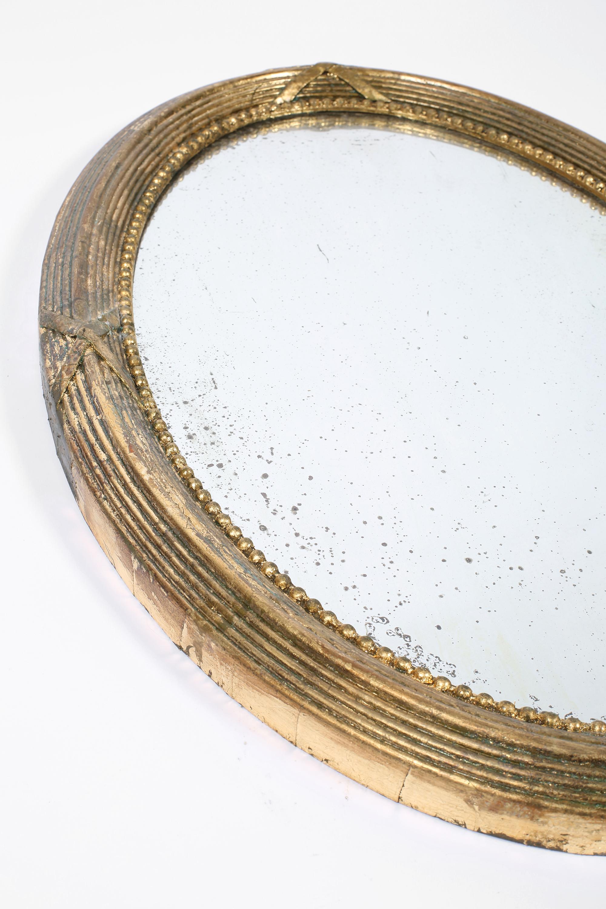English Victorian Period Gilt Oval Carved Gesso Wall Mirror In Fair Condition For Sale In London, GB