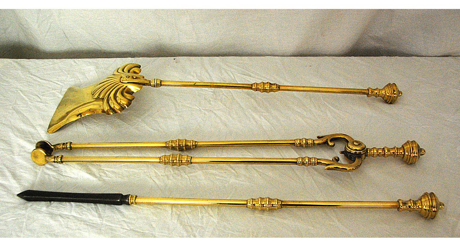 English Victorian period set of three brass firetools, including the shovel, tongs and poker. The poker has a cast iron end for poking hot coals. The shovel is registry dated 1895 (generally speaking only one tool of a set bears the registry date).