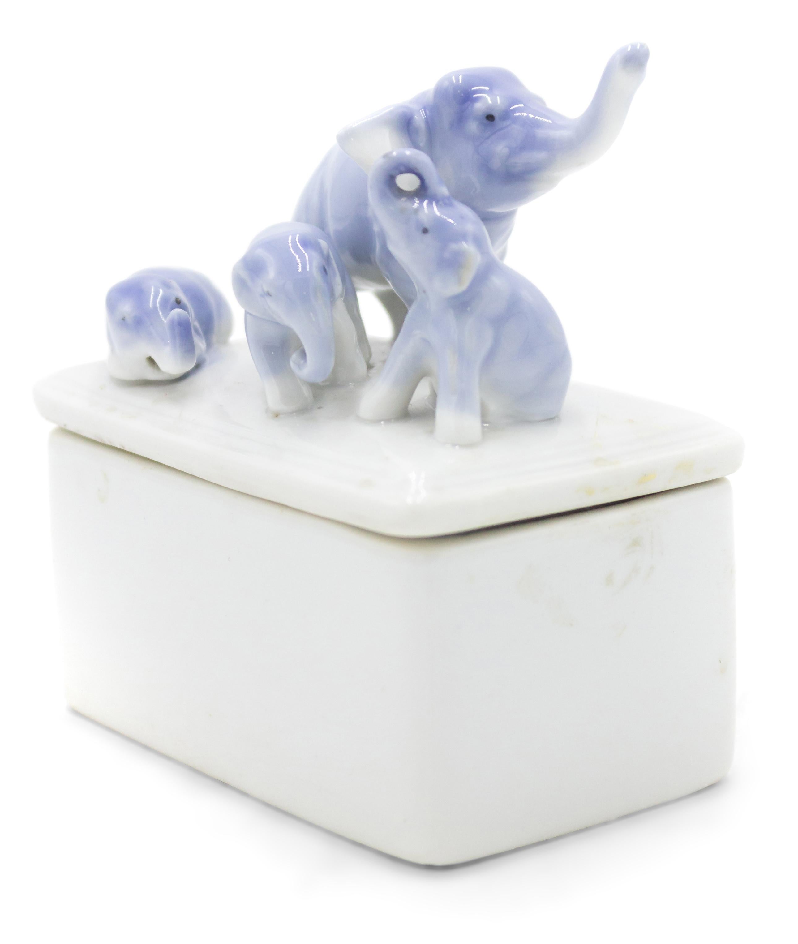 English Victorian small white porcelain box with blue elephant top.
 