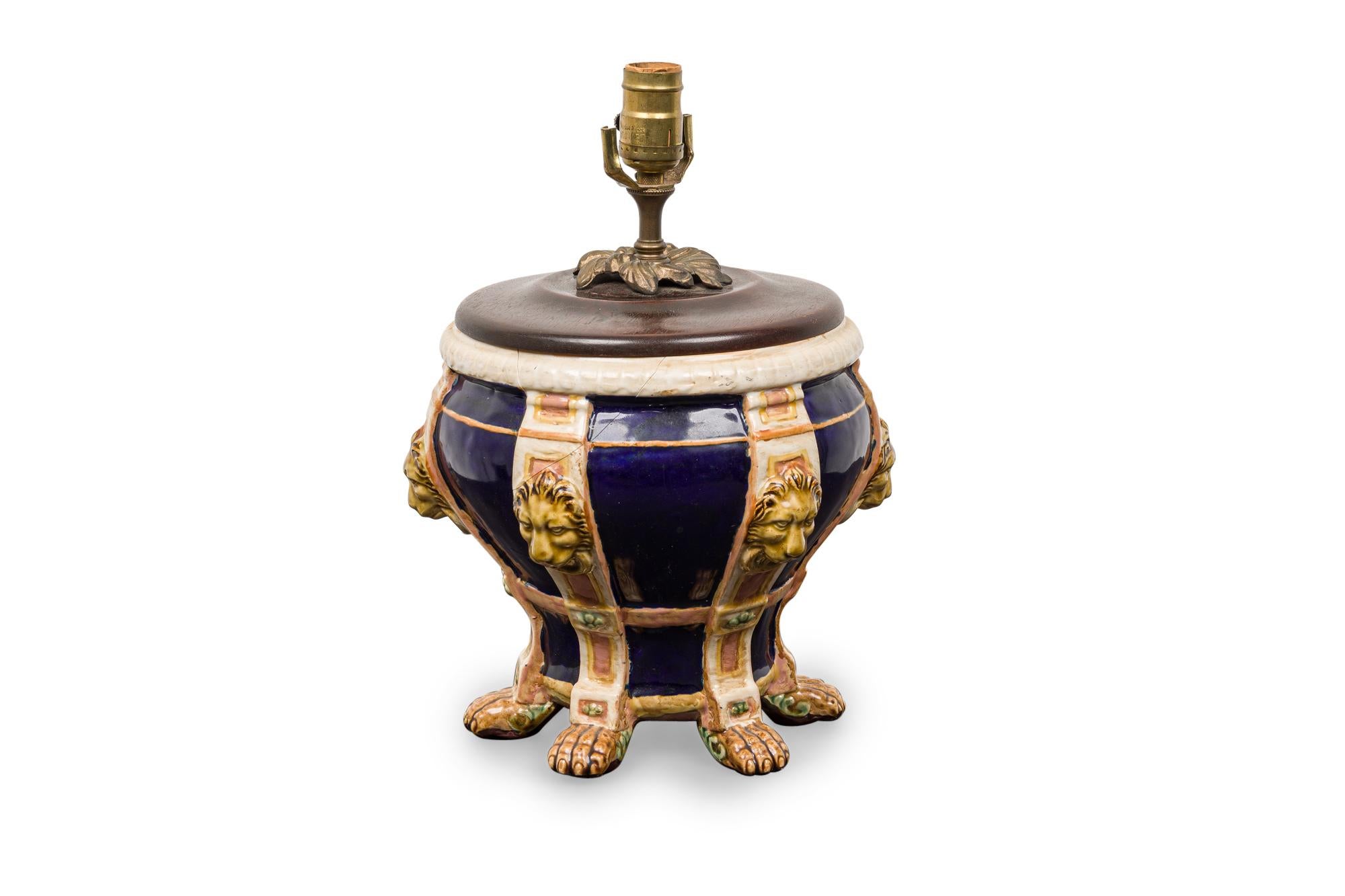 English Victorian blue and beige porcelain table lamp (possibly Minton) having a bulbous shape with 6 lion heads and resting on 6 claw feet