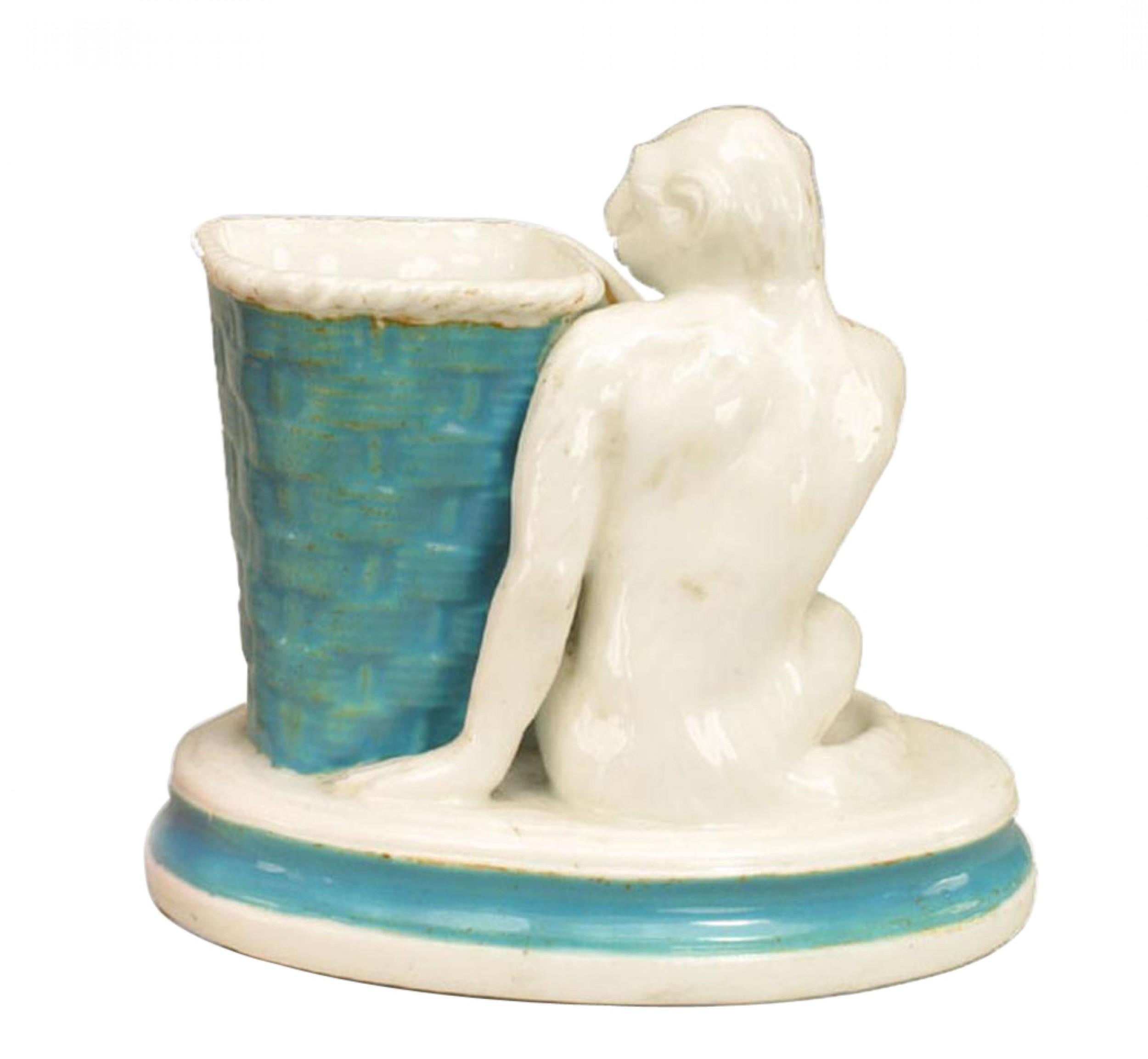 English Victorian porcelain vase with monkey seated next to a blue basket