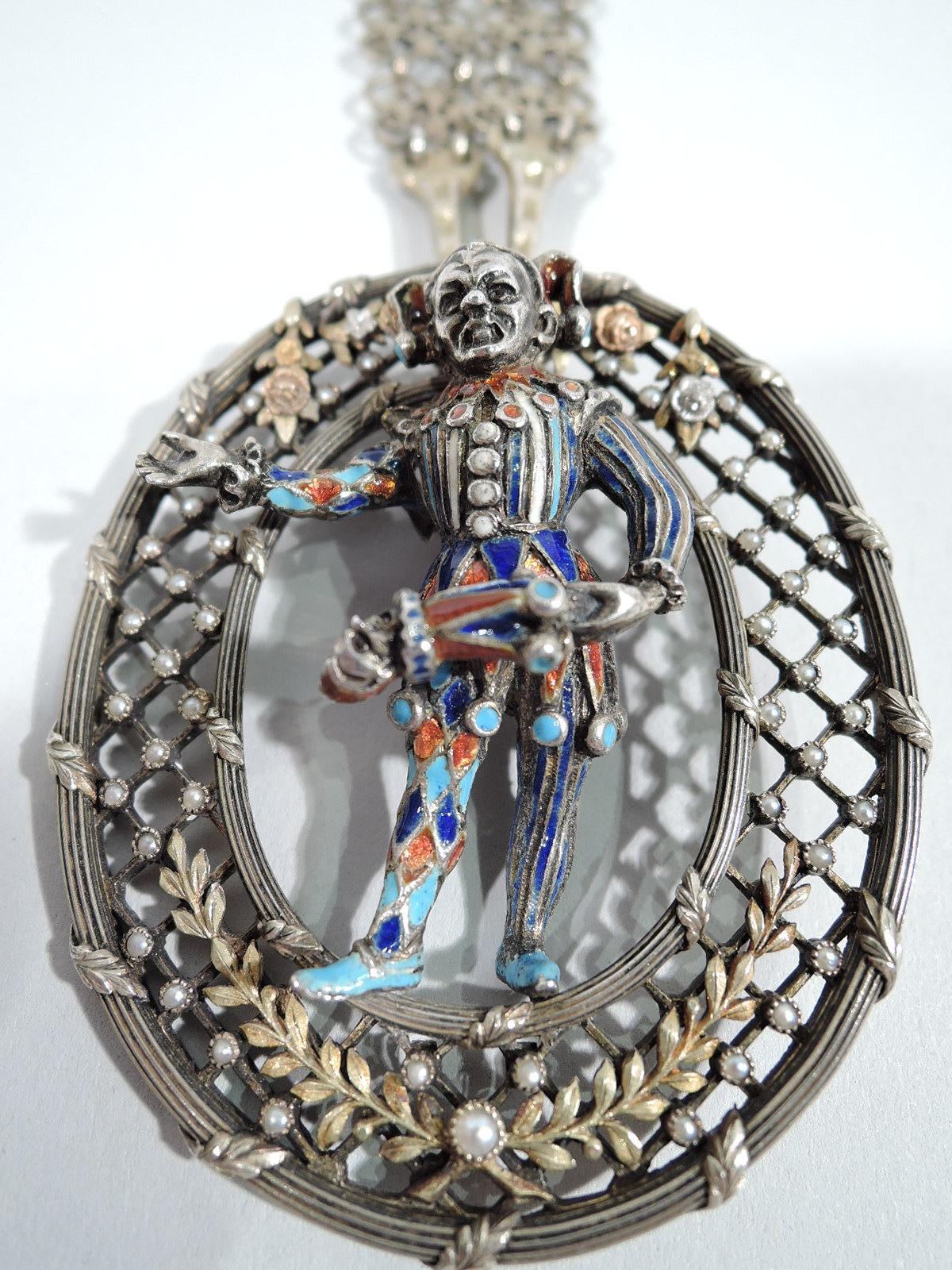 English Renaissance-Revival silver gilt and enamel pendant of jester, ca. 1880. Jester is set in oval with lattice, baby seed pearls, and foliate border with gilt wreaths and flora. With gilt-metal chain. 

Dimensions: Pendant: H 2 3/8 x W 2 in.