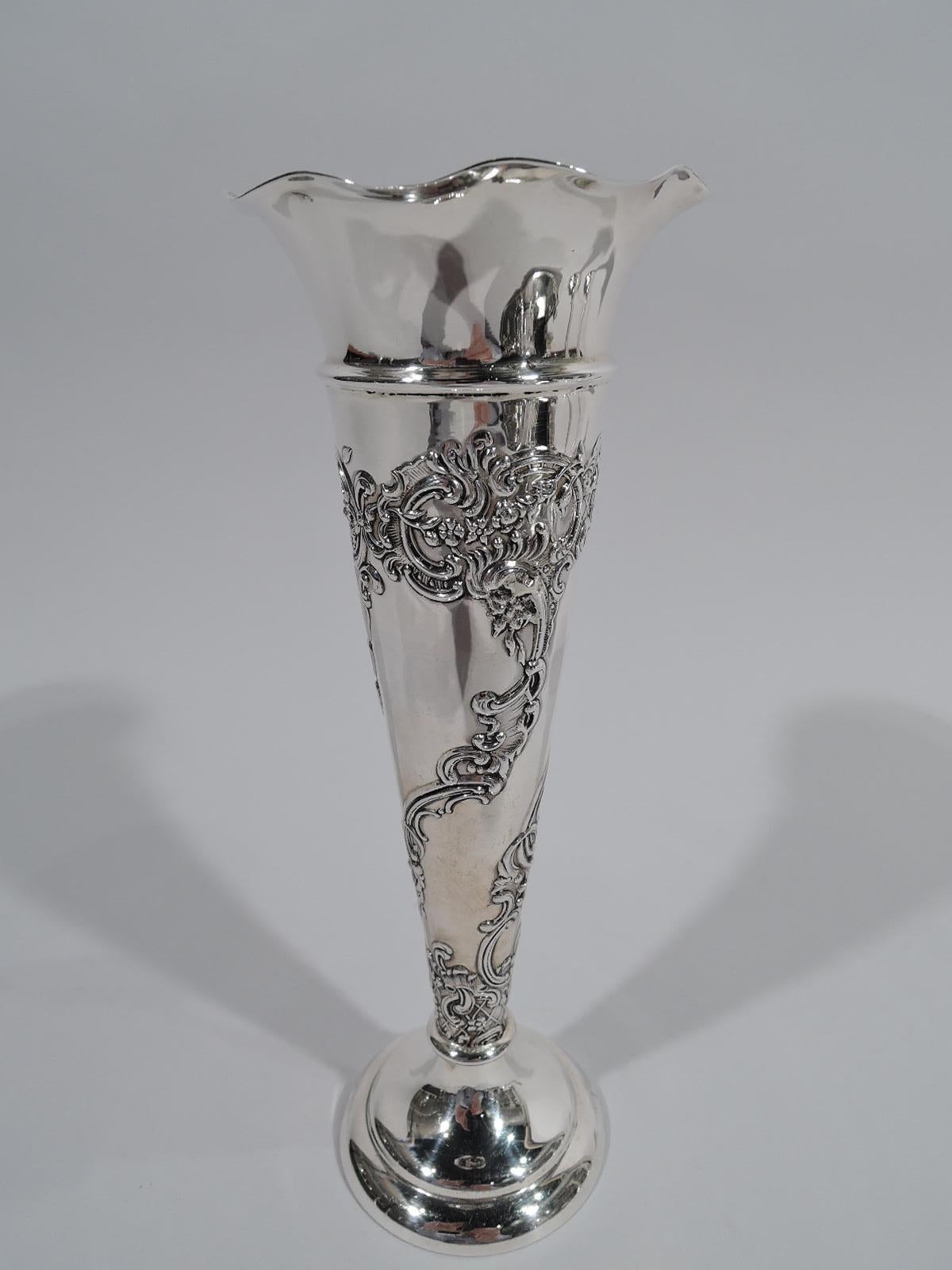 Victorian Rococo sterling silver vase. Made by William Comyns in London in 1900. Conical with ruffled rim. Chased scrolls, diaper, and flowers. Fully marked. Weighted.