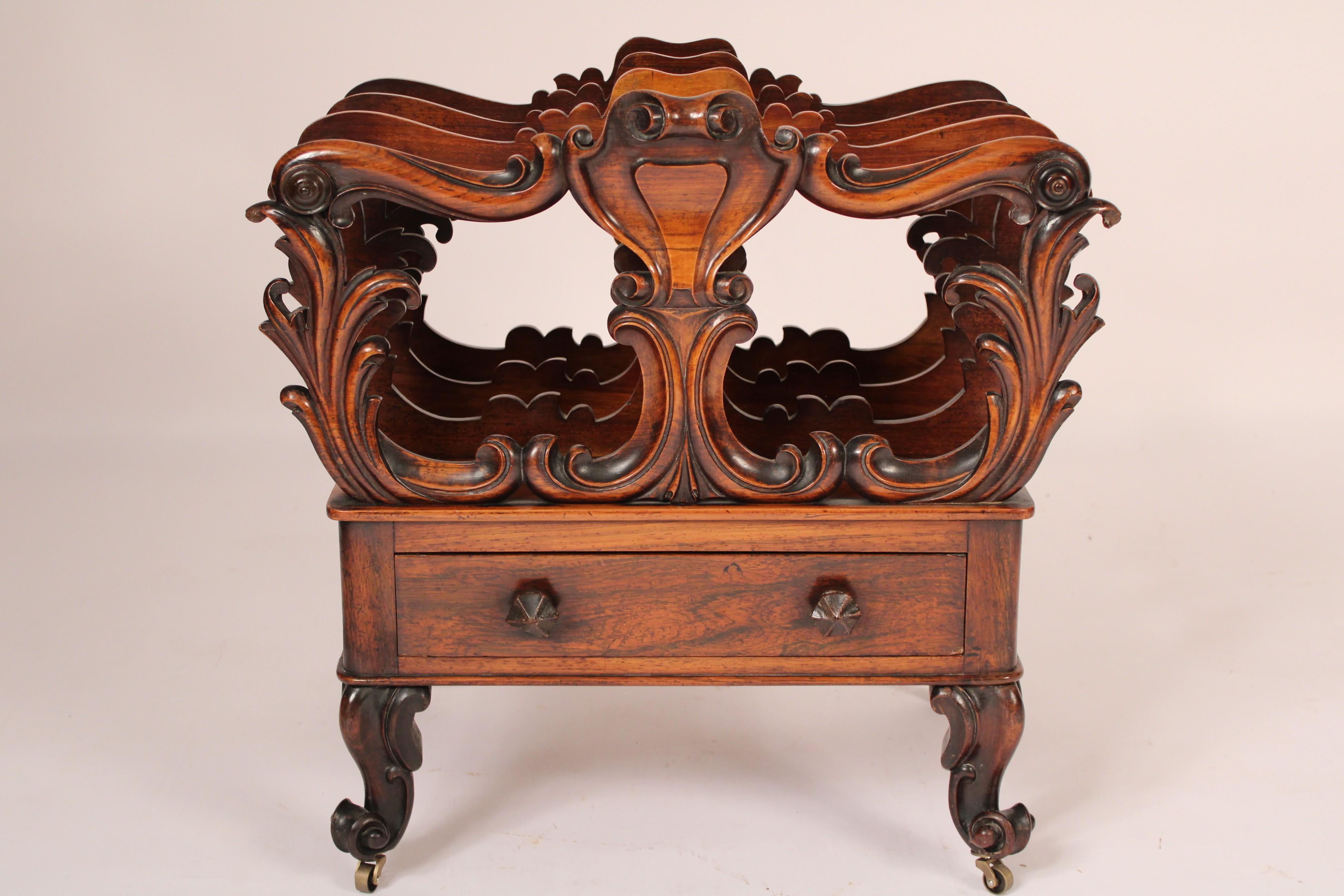 English Victorian rose wood canterbury, mid 19th century. With 3 slots for magazines, the front slot with upper center shield design S shaped tops supported by floral carved vertical supports, a drawer, resting on 4 cabriole legs with French fiddle