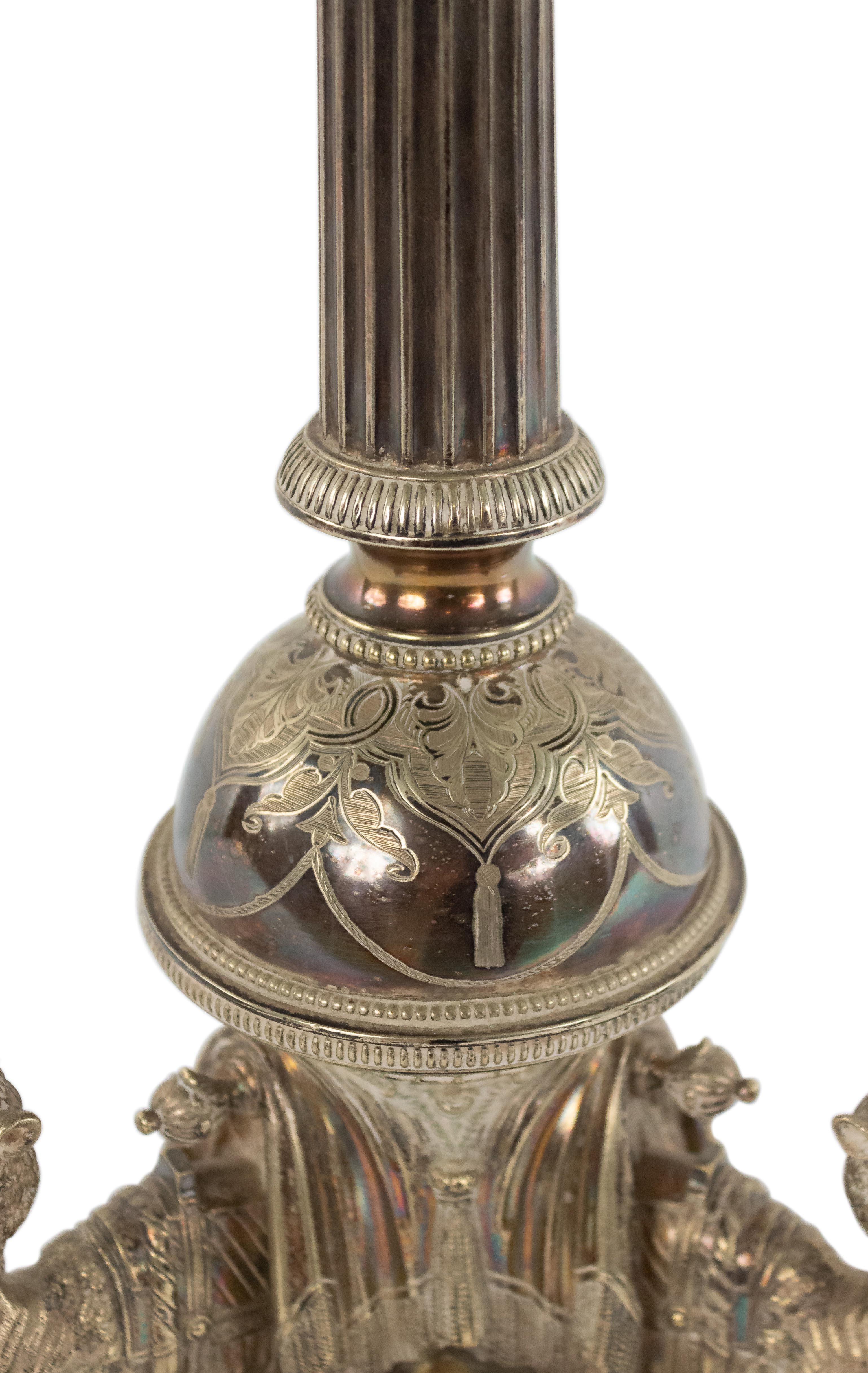 English Victorian (dated 1865) silver plated table lamp with camels kneeling on a tripartite base beneath a fluted columnar shaft.
