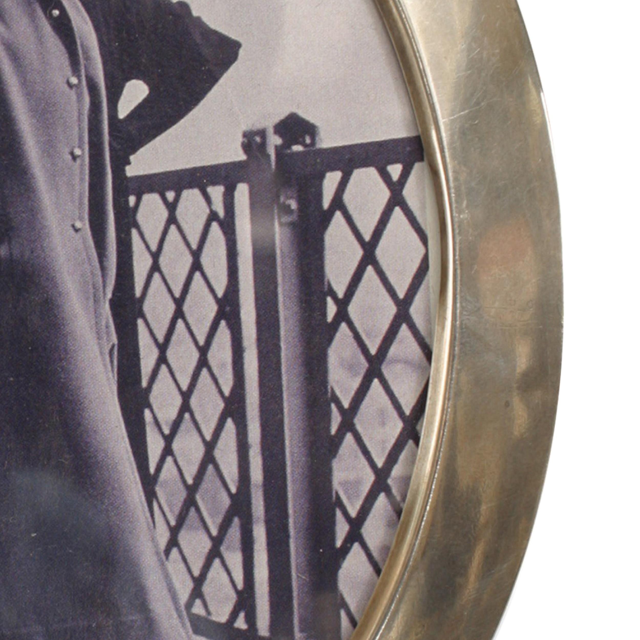 English Victorian oval shaped sterling silver easel picture frame resting on 2 ball feet with plum velvet backing.