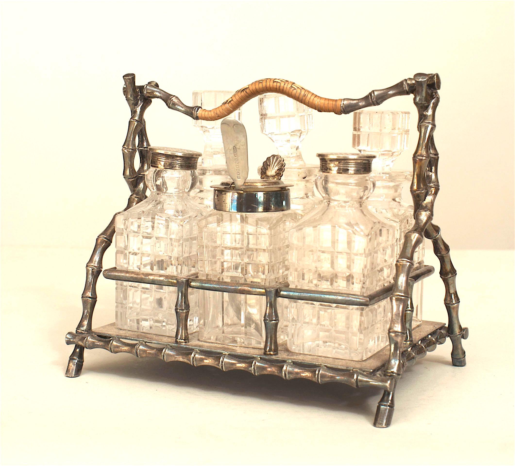 English Victorian silver plate faux bamboo design cruet set with woven wicker handle and 6 cut crystal bottles.
 
