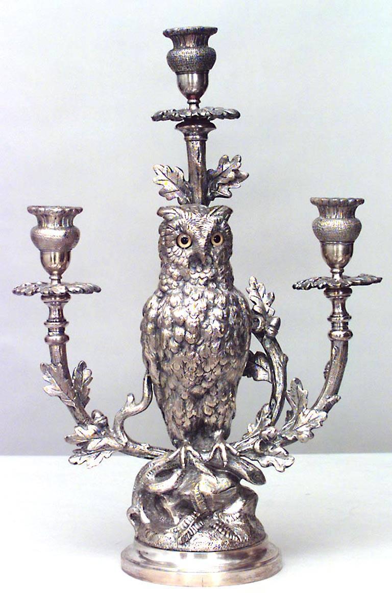 English Victorian silver-plated owl design clock and pair of candelabra with oak leaf trim.
 