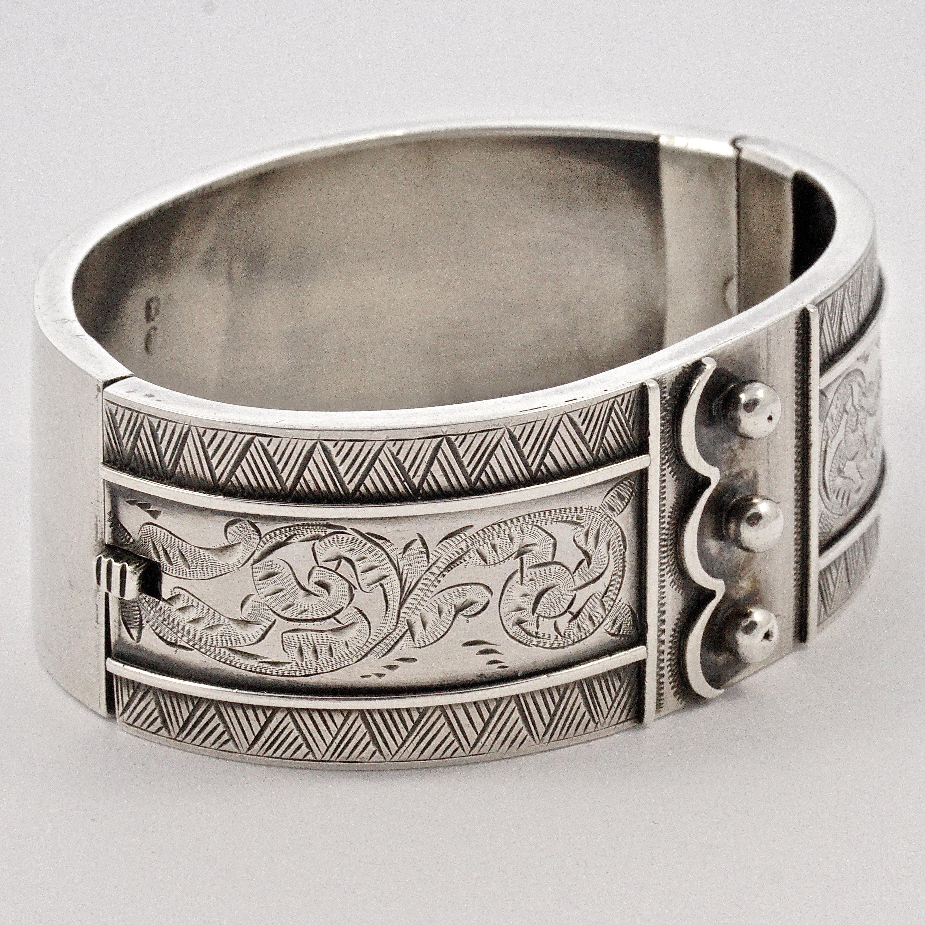 
Beautiful sterling silver triple button cuff hand engraved bangle, with a scroll and geometric pattern. It is slightly oval, the inside measurements are 6.1cm / 2.4 inches by 4.5cm / 1.77 inches, and the width is 2.5cm / .98 inch. The bracelet is
