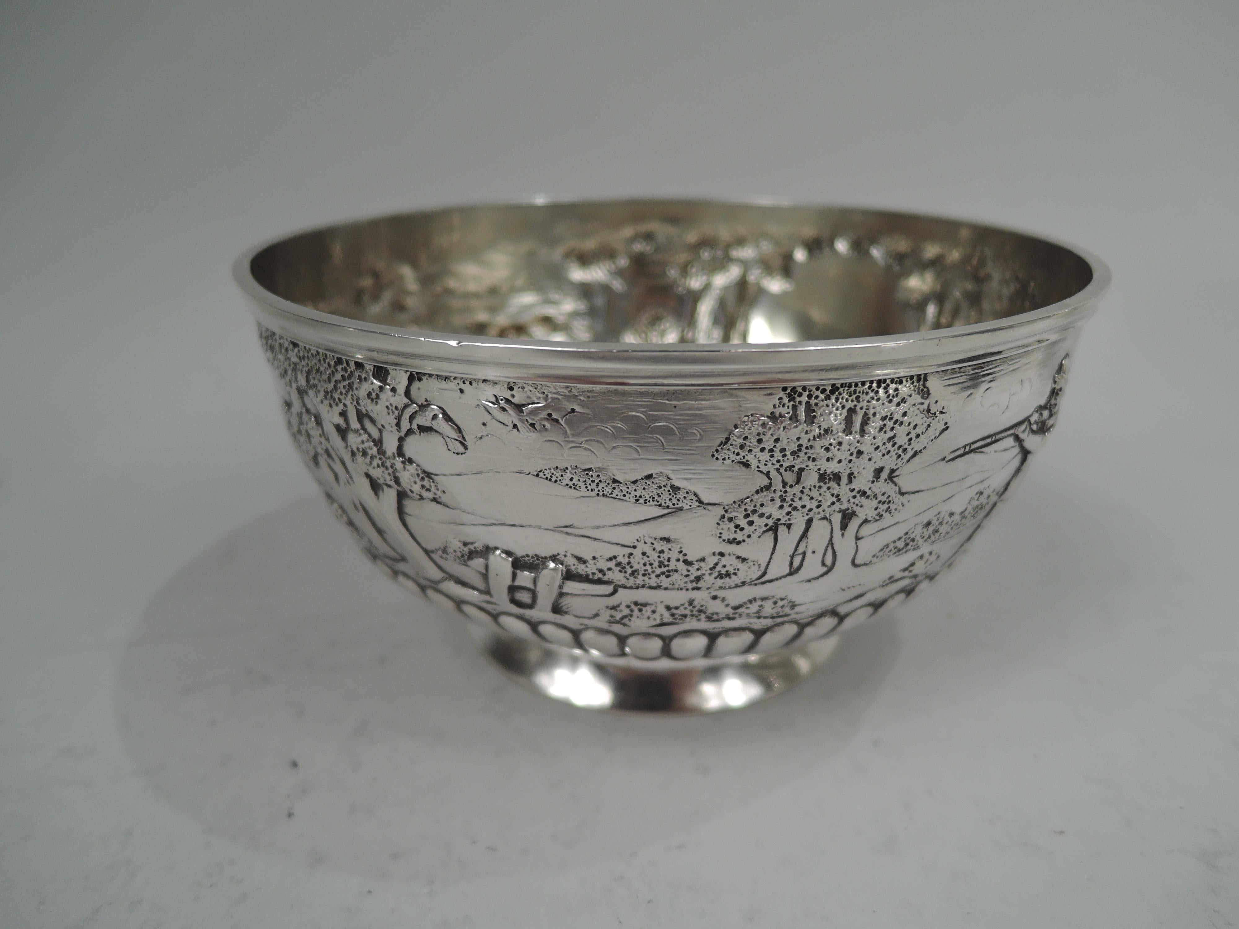Victorian sterling silver bowl. Made by Frederick Brasted in London in 1884. Round and curved with raised and spread foot. At top chased and engraved scene depicting idyllic countryside with rolling hills and big sturdy trees. In foreground a fox is