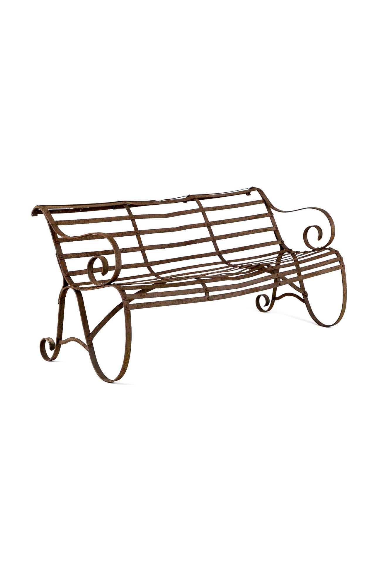 A characterful early Victorian wrought iron strap work bench in the original finish.

The scrolling arms are flanked by a bowed strap work back.

The curved wide slatted seat stands on a pair of wide scrolling legs supported by diagonal