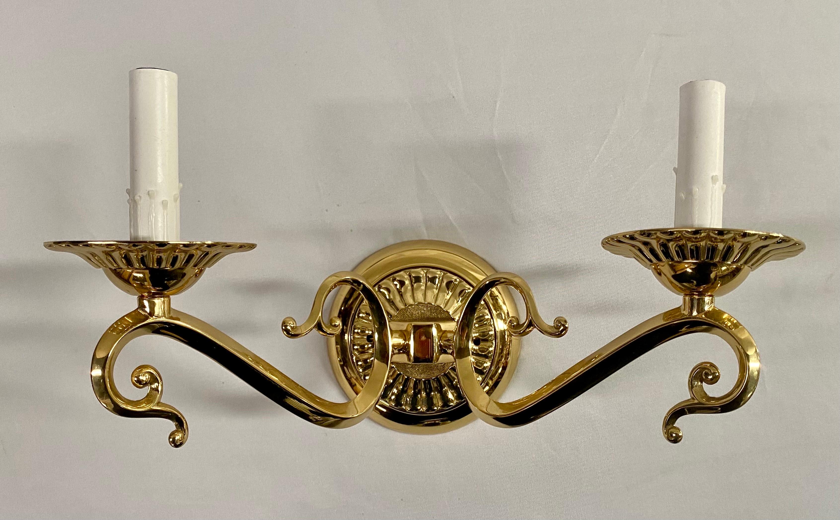 Transport yourself to the elegant era of English Victorian charm with these exquisite brass wall sconces. Each sconce, a masterpiece in its own right, boasts two arcing arms that evoke the essence of a bygone era. These arms are adorned with a
