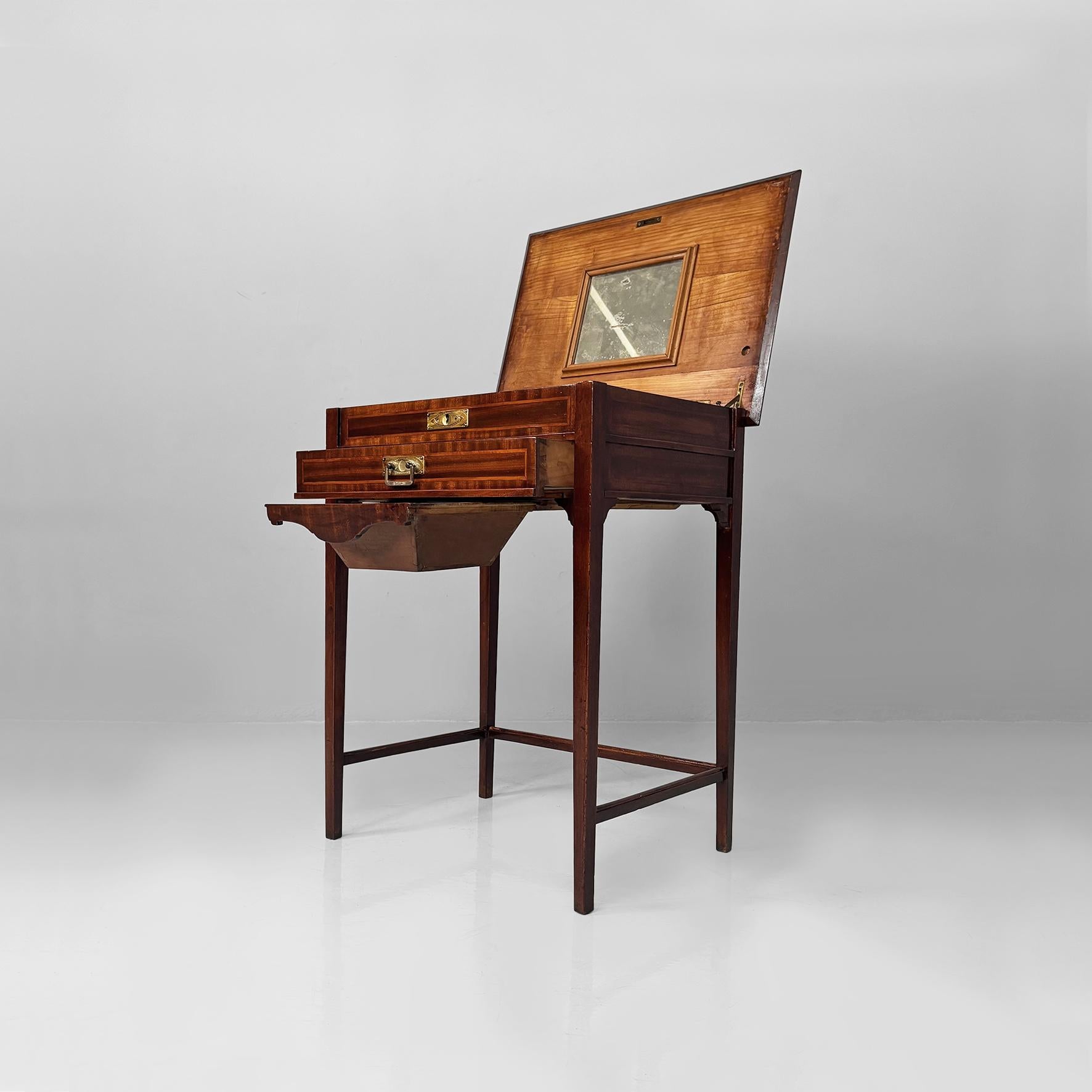 Console anglaise de style victorien en bois avec miroir et tiroirs, années 1930
Table console avec miroir en bois. La partie supérieure comporte un compartiment rabattable avec serrure en laiton, à l'intérieur duquel se trouvent un miroir et de