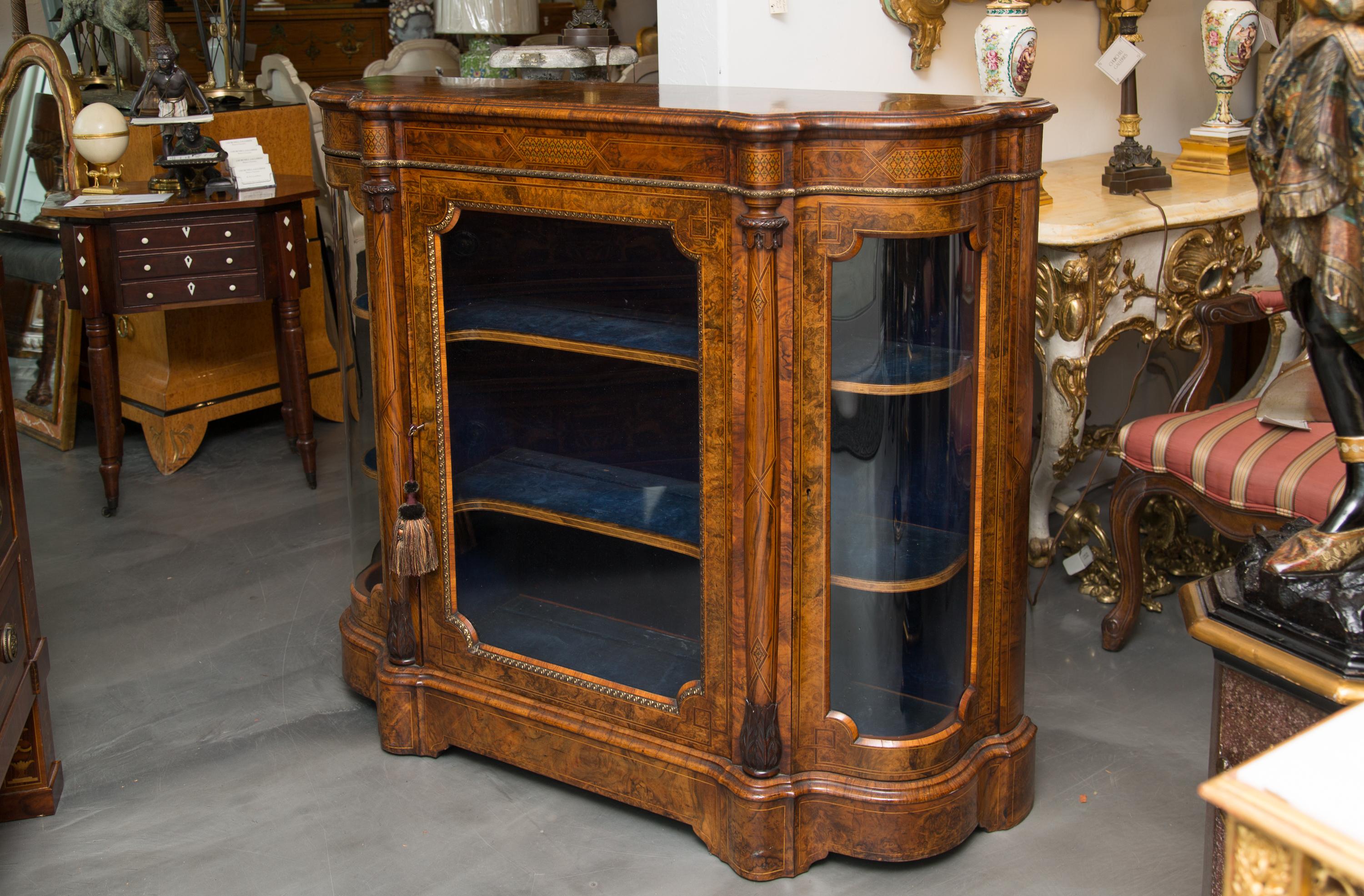 This is an exquisite walnut root and burl wood display cabinet with exceptional inlay work, 19th century.