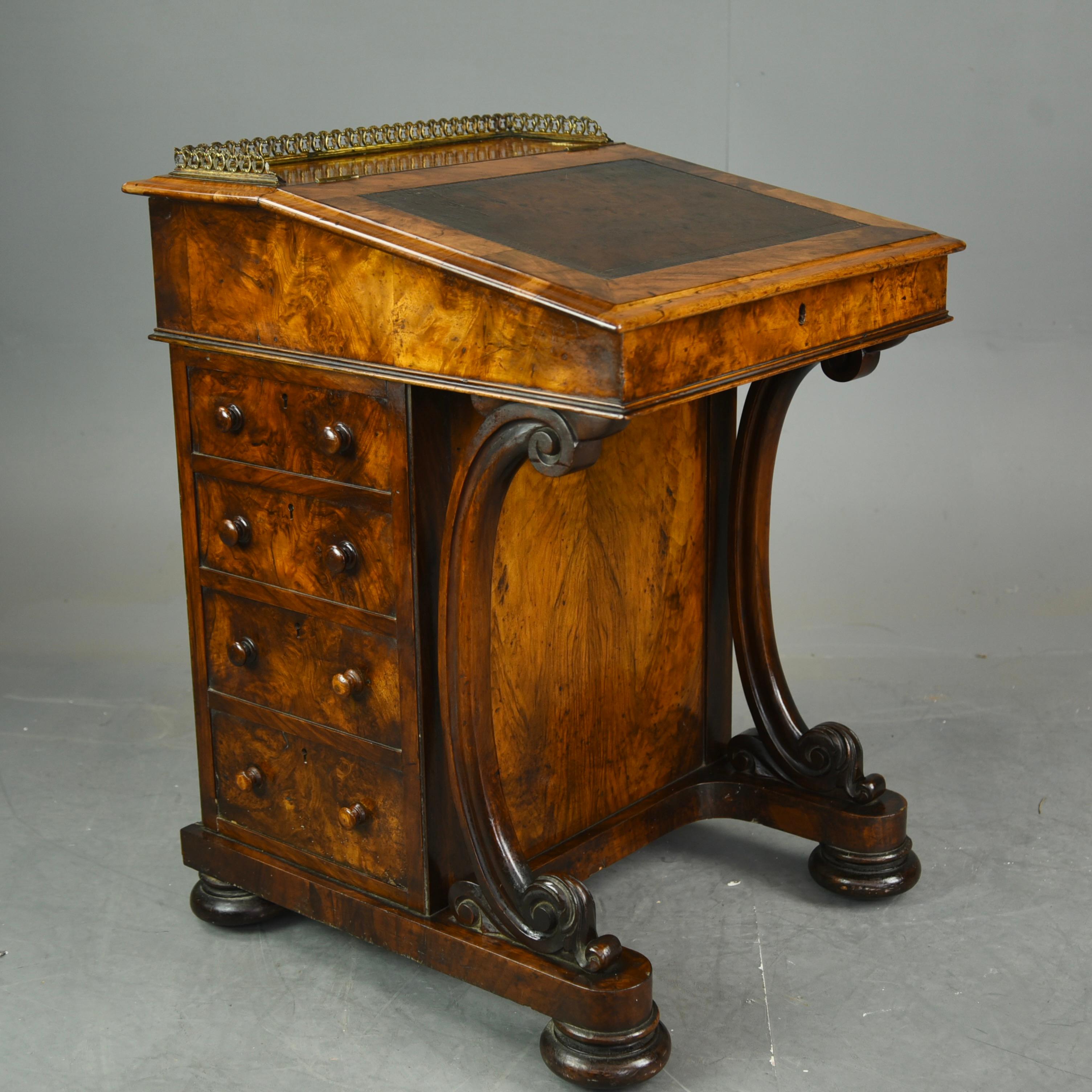 Outstanding quality antique Victorian burr walnut davenport having a gallery top above a lift up top with the original brown leather writing surface cross banded in walnut. The top opens to reveal a fitted interior with two drawers and two dummy