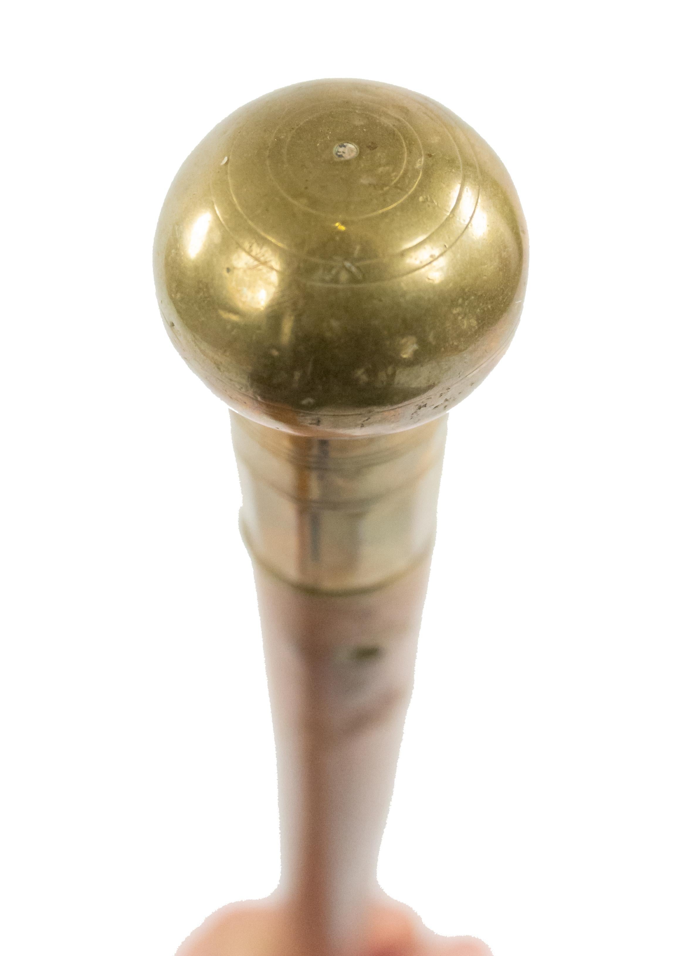 English Victorian light wood cane with brass ball top and fluted sleeve.
 