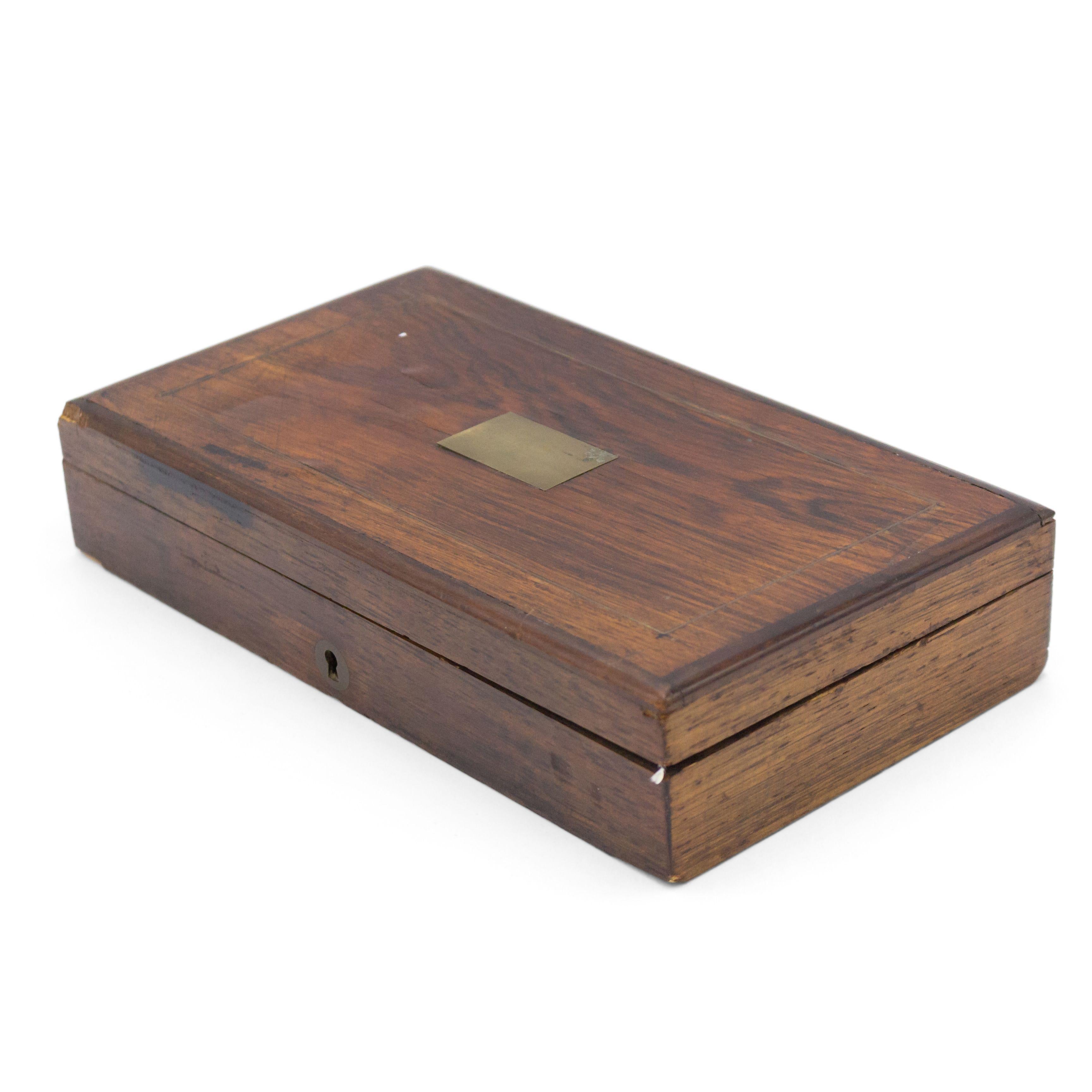 English Victorian style rectangular wood box with a brass escutcheon and a rectangular brass inlay on lid.
       