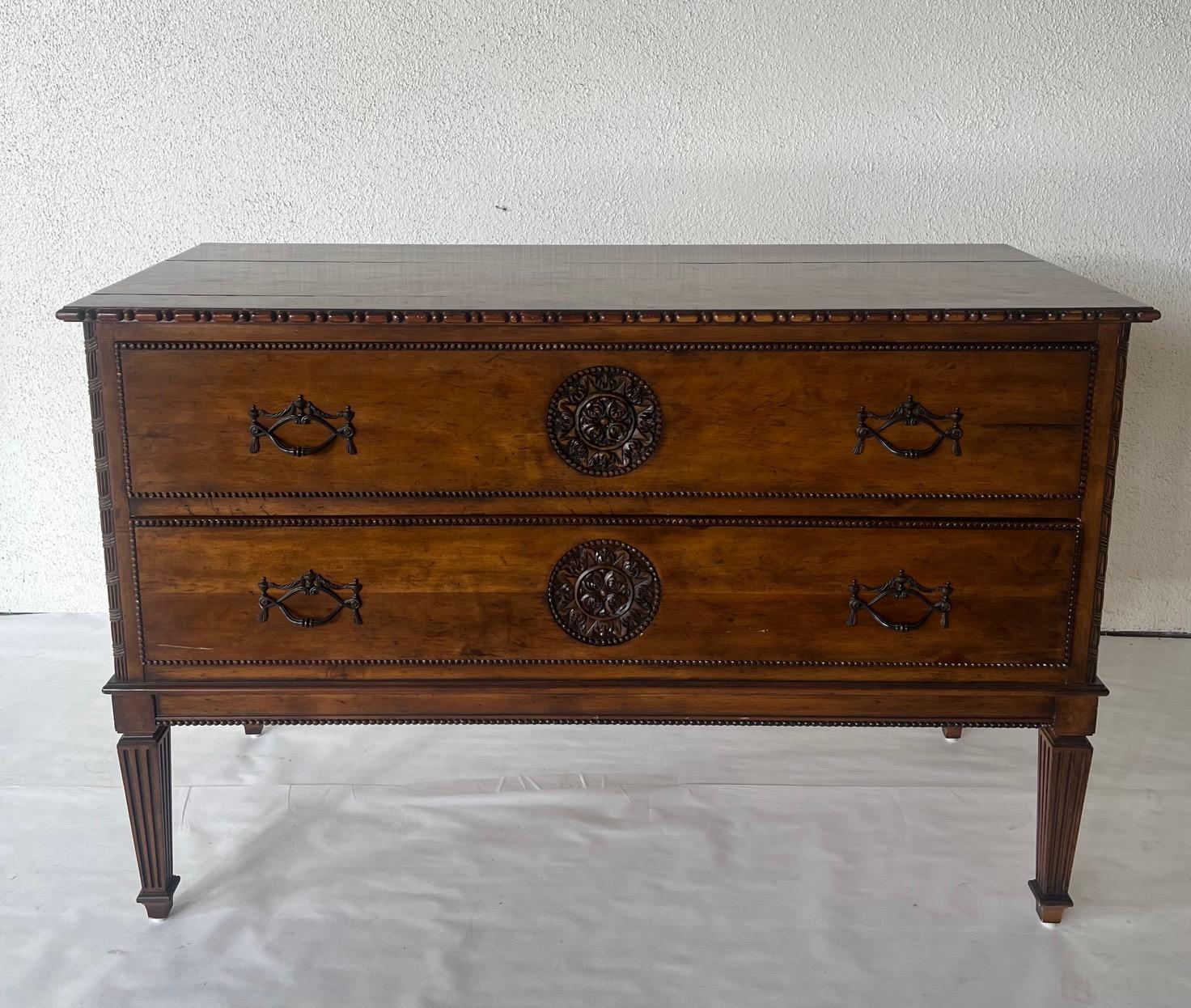 Imported English Chest of drawers with center carved medallions on each drawer. Carved border surround with original hardware. Very detailed chest.