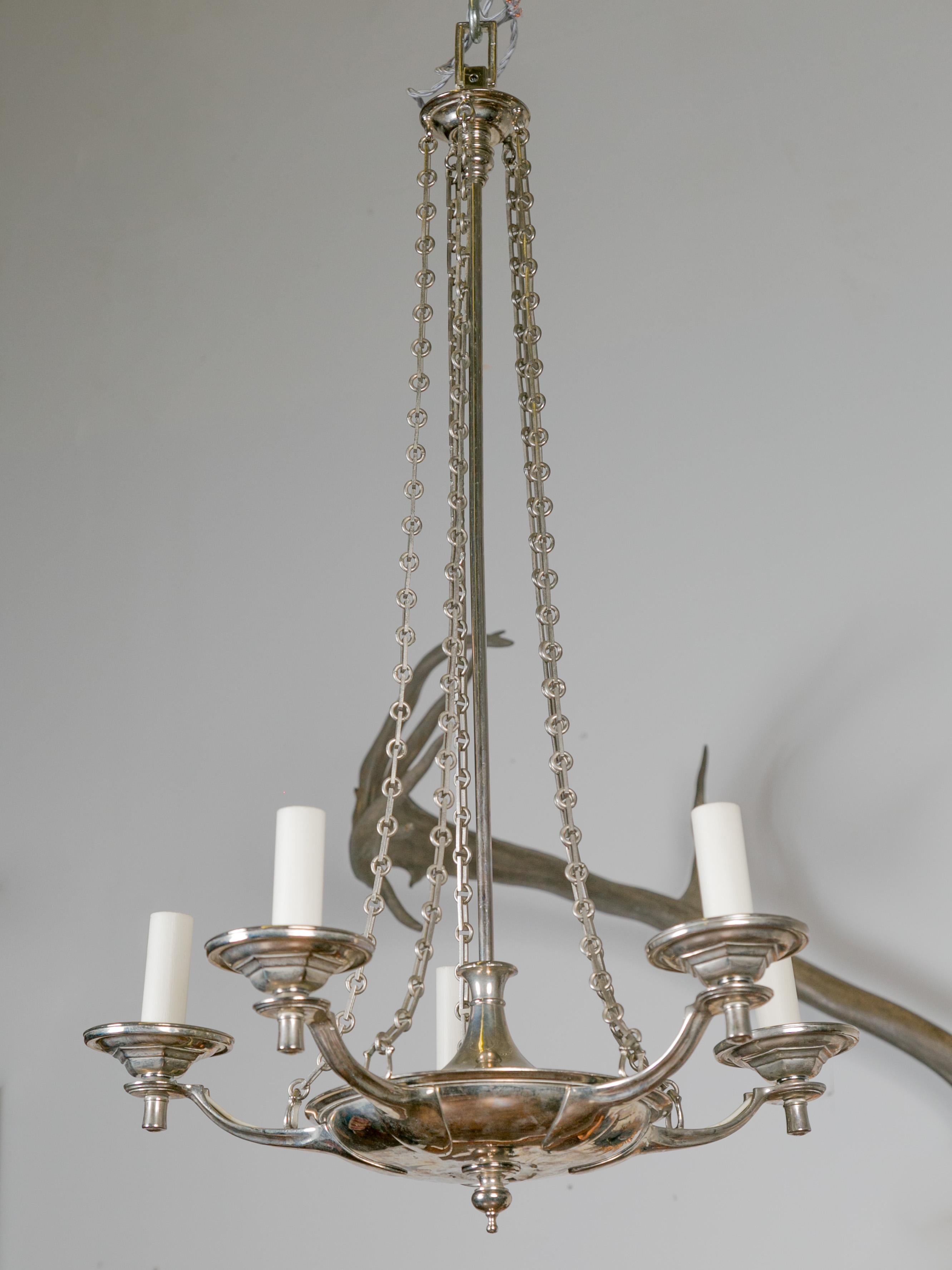 An English vintage five-light nickel chandelier from the late 20th century, with profiled links. Created in England during the third quarter of the 20th century, this nickel chandelier features a central rod with upper canopy from which are hanging